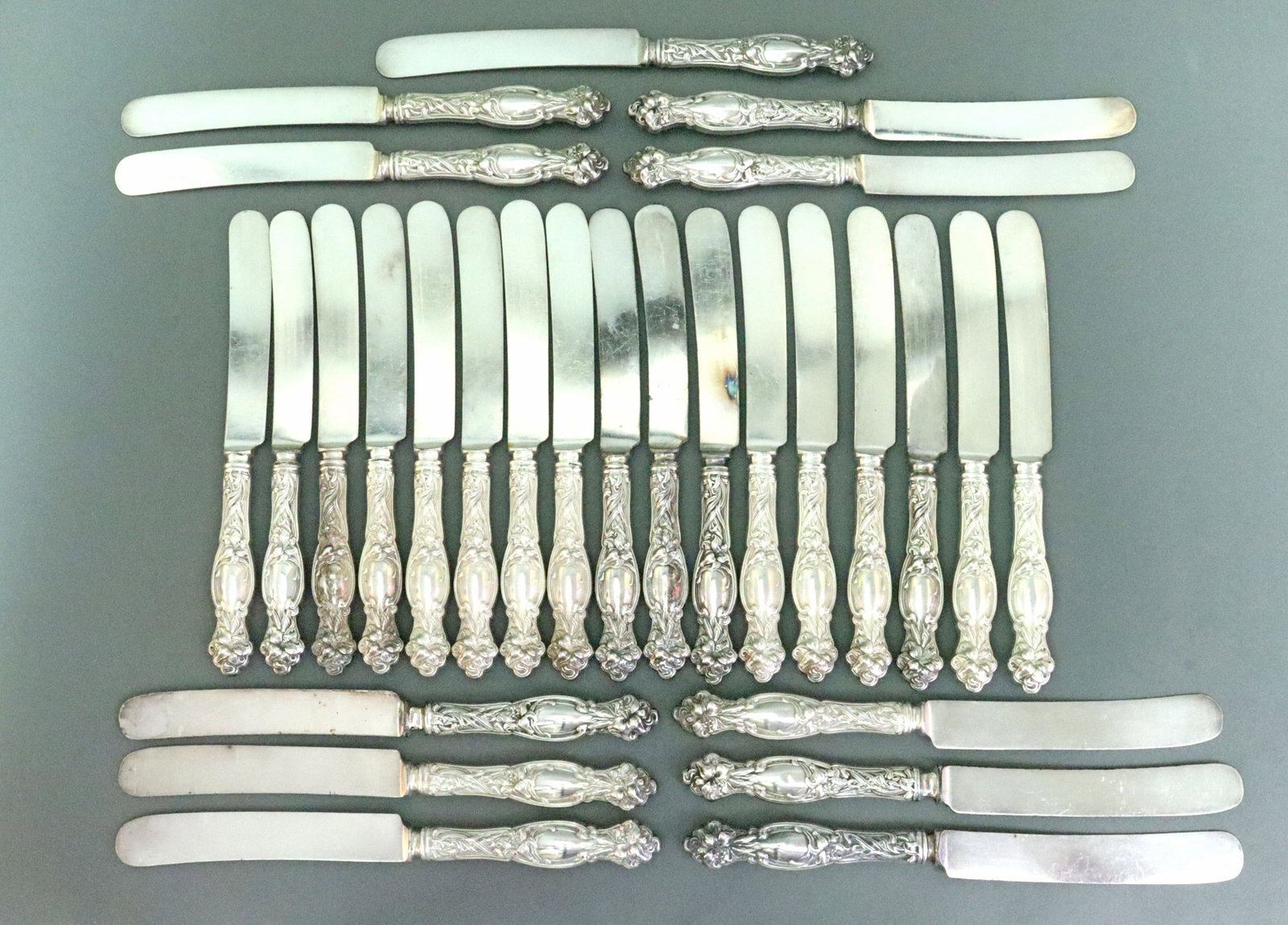 (28) INTERNATIONAL SILVER PLACE KNIVES: sterling handles, in Frontenac pattern- 2 sizes, including 17 (9in.), and 11 (9.75in.), gross weight 60.1ozt., monogrammed, Opening Bid $500
