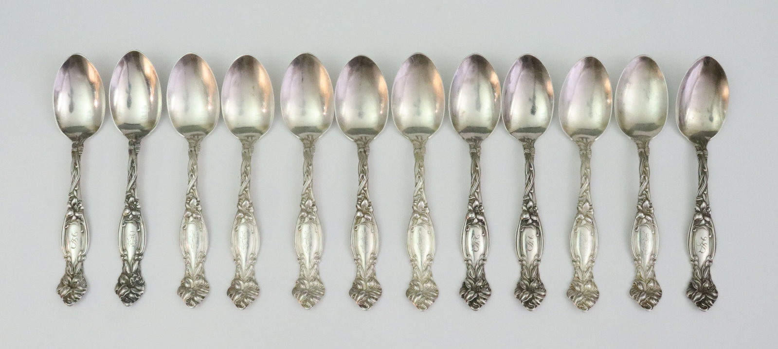 (12) INTERNATIONAL SILVER STERLING TEASPOONS: in Frontenac pattern, 5.8in., monogrammed, 10ozt., Opening Bid $400