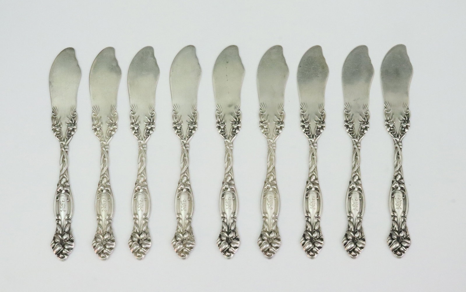 (9) INTERNATIONAL SILVER STERLING BUTTER SPREADERS: in Frontenac pattern, 5.75in., monogrammed, 7.6ozt., Opening Bid $300