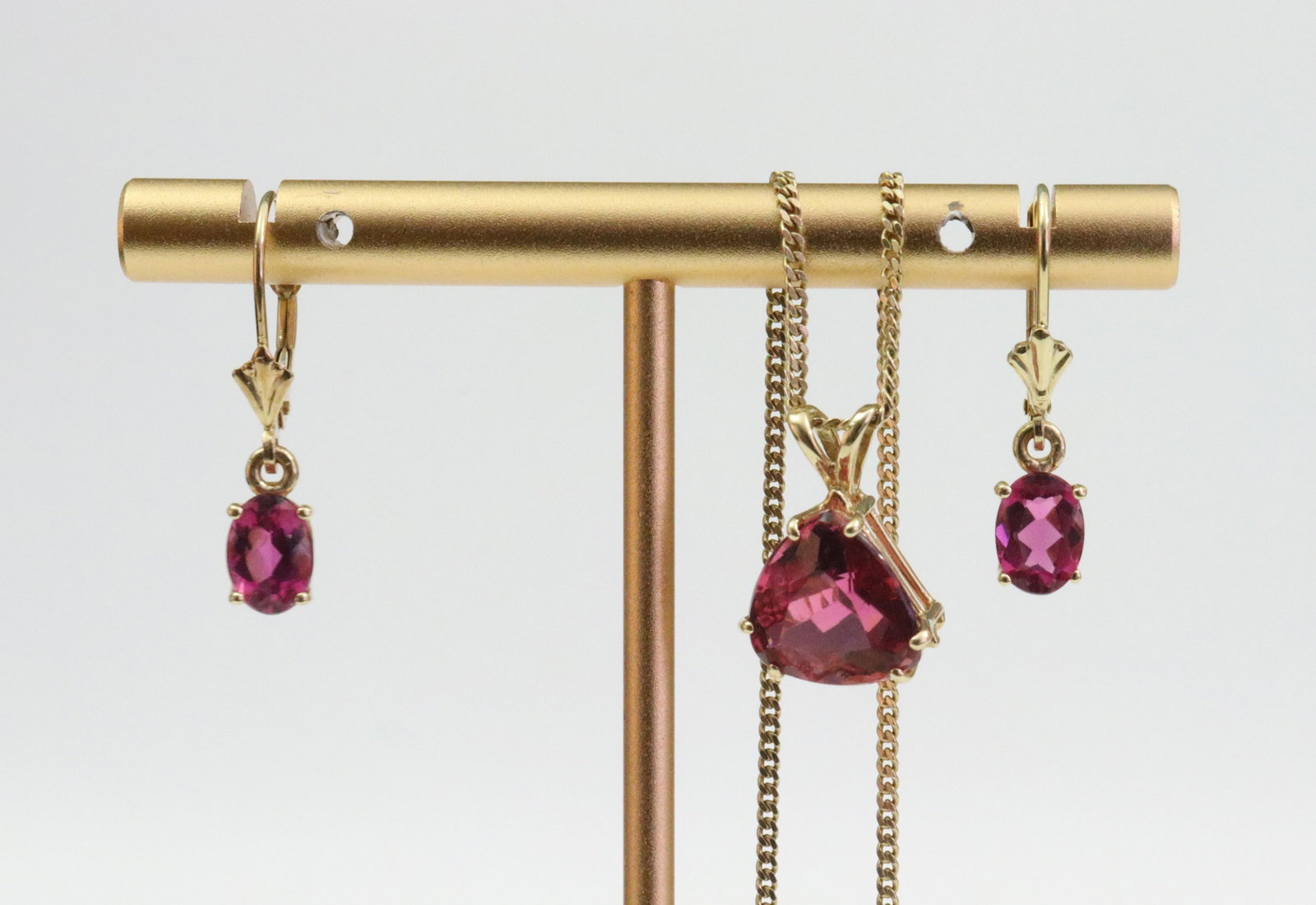 14K PINK TOURMALINE PENDANT & EARRINGS: including a (10x10mm) trillion-cut pink tourmaline pendant on 18.5" curb link neckchain (2.6gms.), and a pair of complimenting leverback drop earrings each set with an oval (7x5mm) pink tourmaline sto
