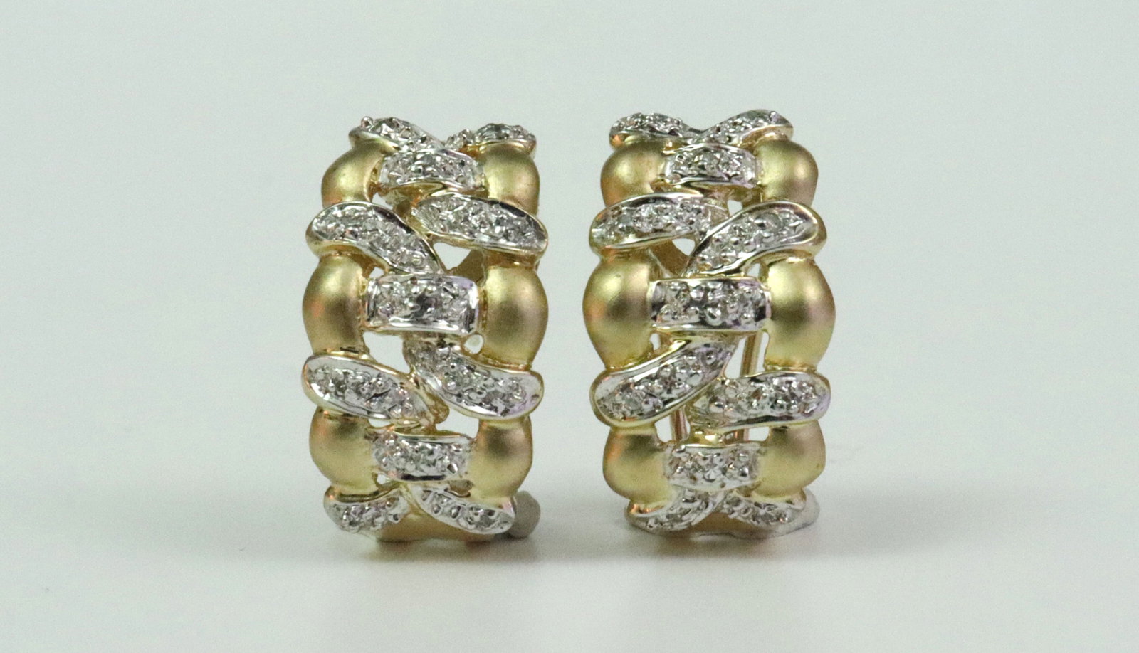 PAIR 14K DIAMOND HUGGIE EARRINGS: each set with 11 natural melee diamonds, in yellow brushed gold (diamonds set in white gold), stamped '14K 585', width 11mm, length 19mm, 6.8gms., Opening Bid $300