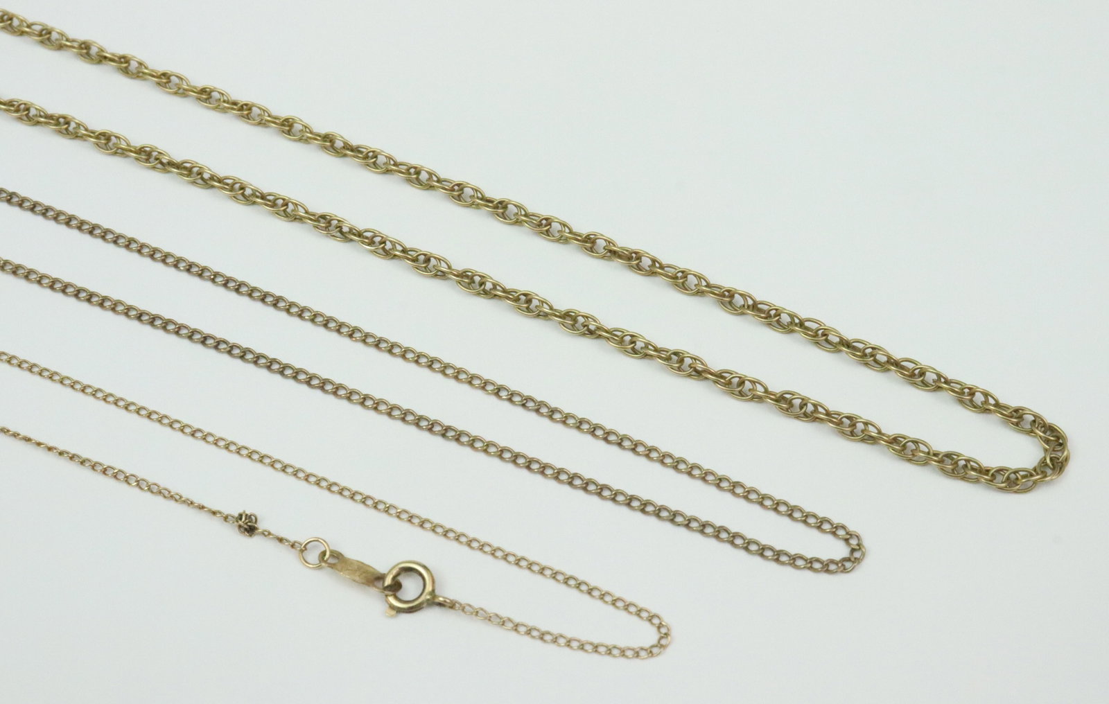 (3) 14K AS-IS GOLD CHAIN NECKLACES: including a 22" Prince of Wales chain (no clasp), a 19" cable link trace chain (no clasp), and a 15" cable link trace chain (chain separated, small kink), all stamped or tested 14K, gross weight