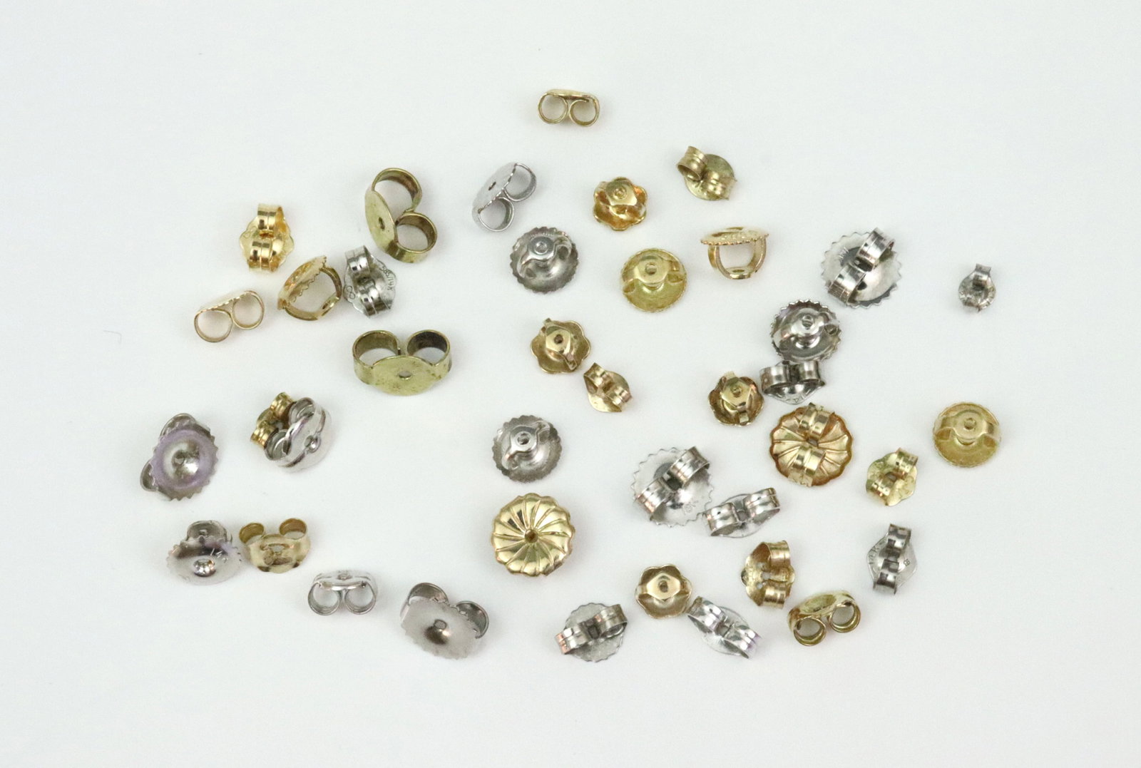 (40) 14K SCRAP GOLD EARRING BACKS: in yellow and white gold, all stamped or tested 14K (except 4 backs stamped 18K, one back stamped 10K), pairs not guaranteed, 5.6gms., Opening Bid $200