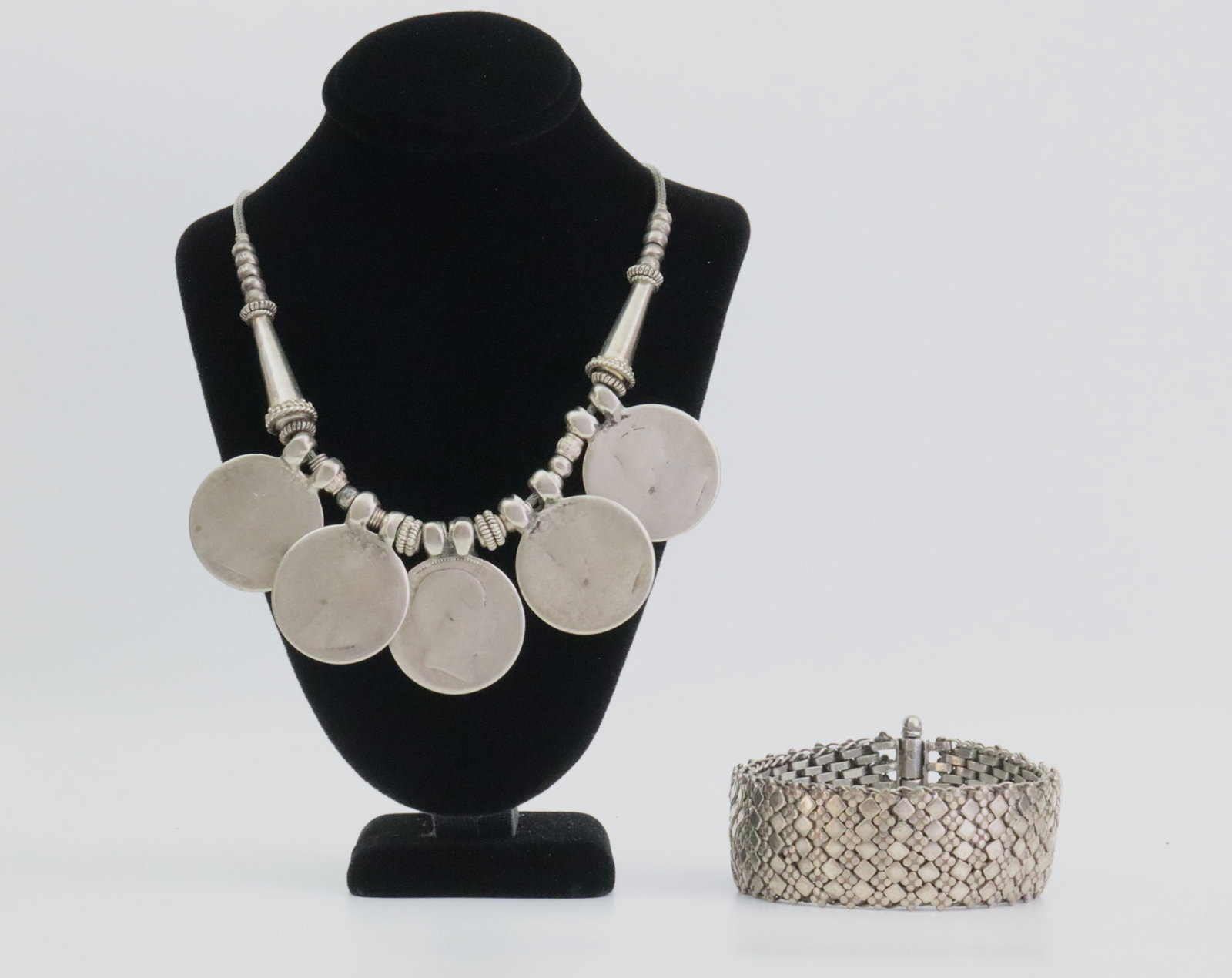 (2) PIECE SILVER JEWELRY GROUP: including a heavy mesh bracelet with slide-out tube clasp, width 1in., length 8in., tests silver, and an Indian necklace set with (5) 1 Rupee British India coins dating from early 20thC., 18in., all