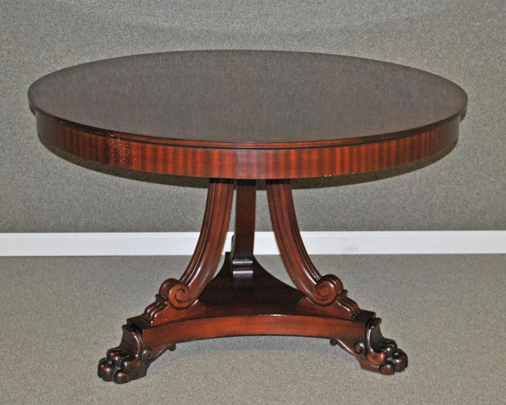 HICKORY CHAIR FIGURED MAHOGANY CENTER TABLE: in round form with banding and inlaid ebony stringing, on tripod pedestal base ending in large paw feet, label of Hickory Chair Co. (scattered dings and scuffs commensurate with age and use), 31x48in.