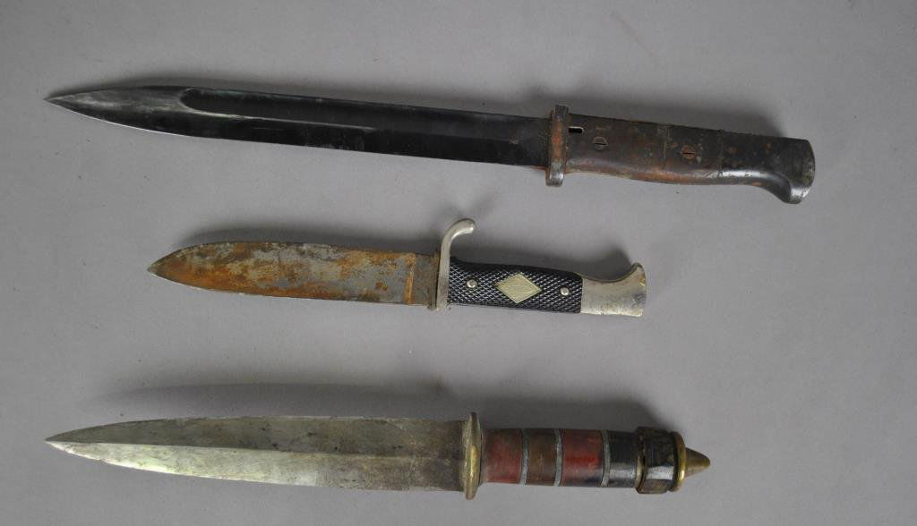 THREE VINTAGE EDGED WEAPONS: including a German Mauser bayonet marked S/185, a Solingen knife with Boy Scout Logo on handle (mismatched sheath), and a trench knife (all with varying degrees of oxidation), all with scabbards or sh