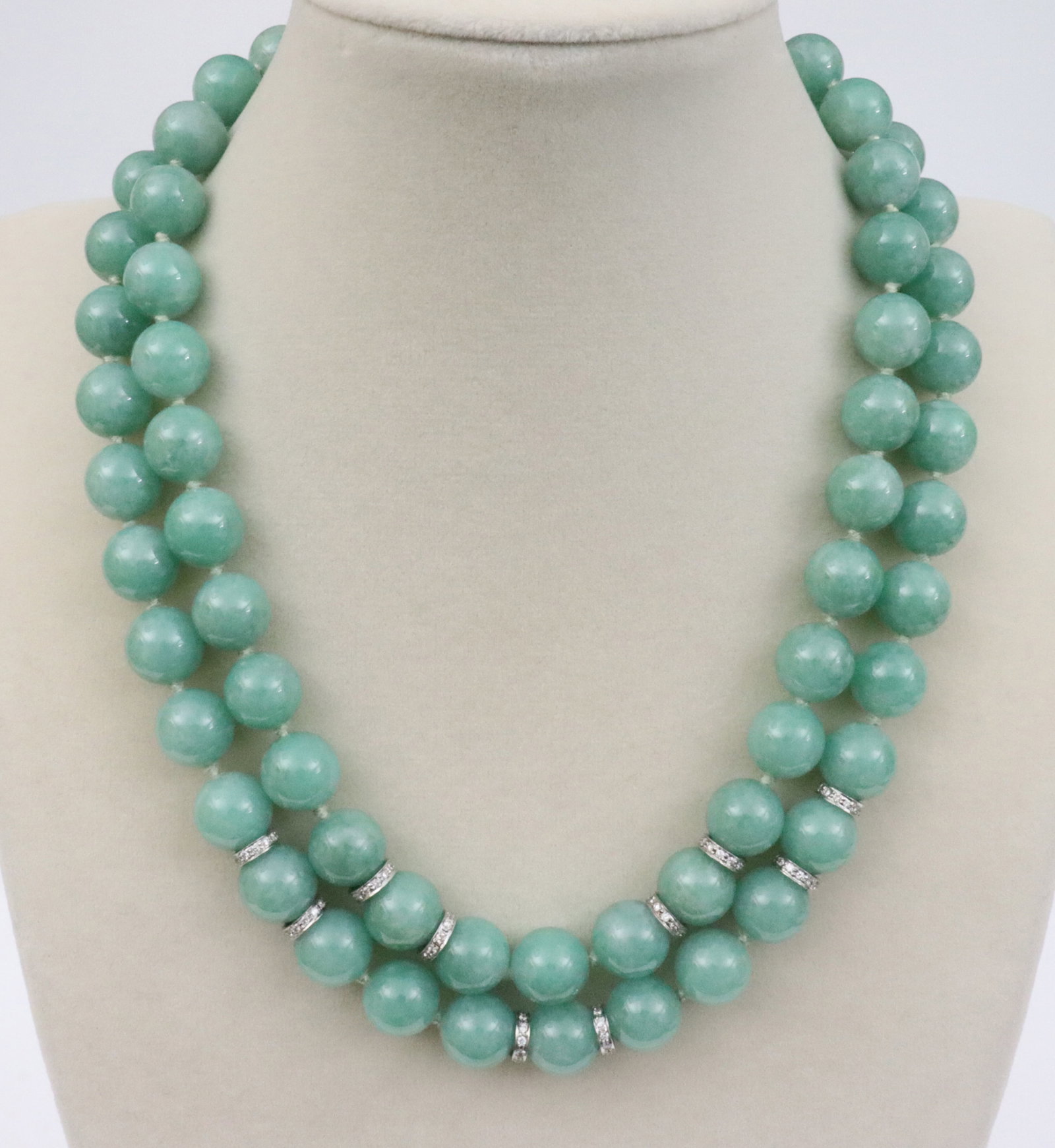 PAIR SEAMAN SCHEPPS 18K JADE & DIAMOND NECKLACES: a nesting set of jade bead necklaces with natural diamond rondelles, the outside strand comprising 37 jade beads and 6 rondelles, 19in., the inside strand comprising 34 jade beads and 4 rondelles,