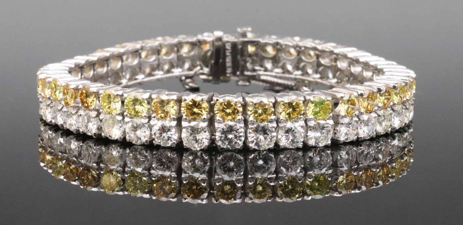 PLATINUM & DIAMOND TENNIS BRACELET, 20.00CTW: designed as a two-row tennis bracelet comprising 84 round brilliant-cut natural diamonds in canary yellow and white (in our opinion: H color, VS-SI clarity, however not guaranteed), total diamond