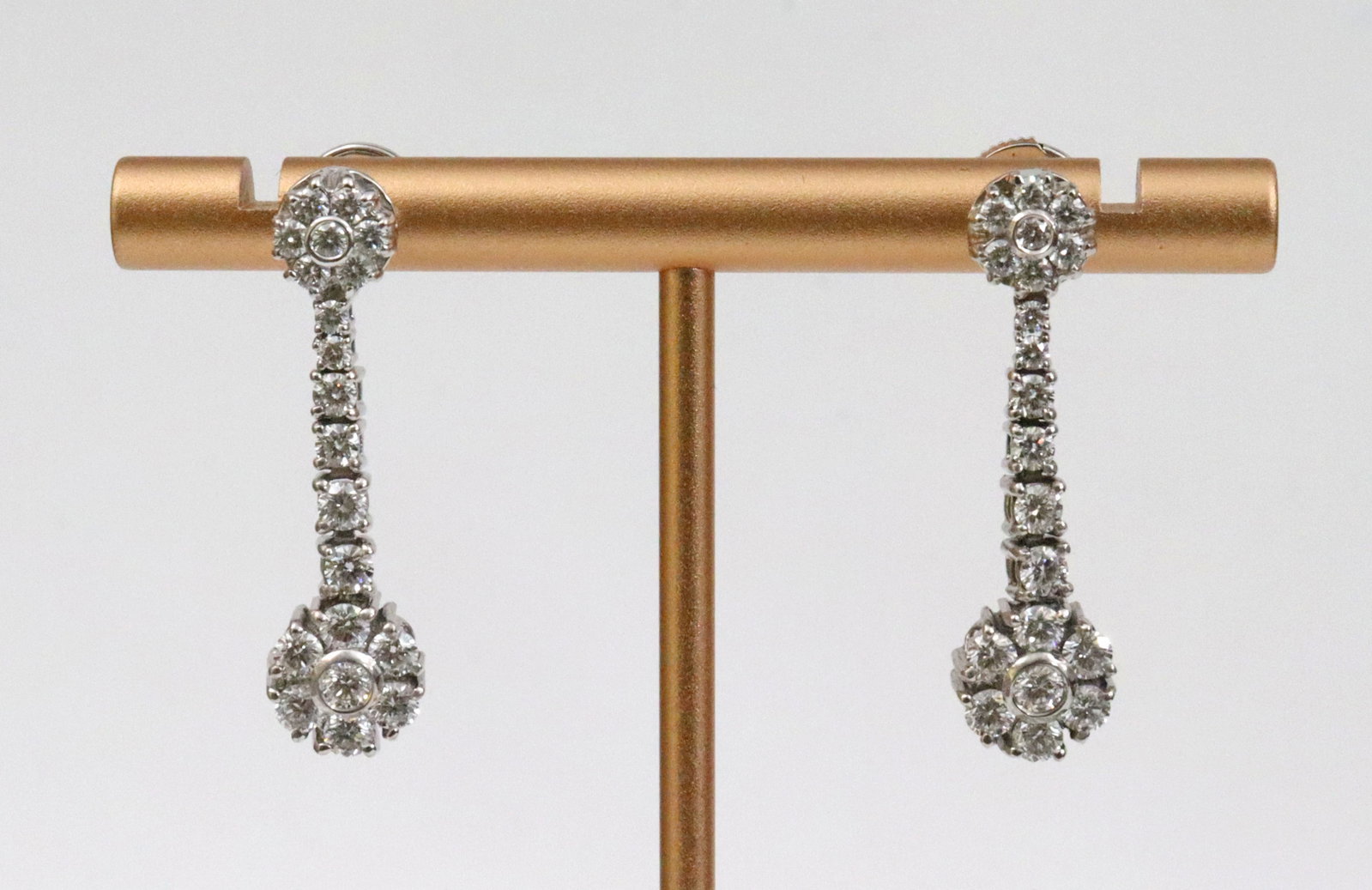 PAIR 18K DIAMOND FLOWER-FORM DANGLE EARRINGS: each set with 20 round natural diamonds, total diamond weight for the pair approx. 2.00ctw (in our opinion: E-F color, VVS-VS clarity, however not guaranteed), in white gold, test 18K, one earring sta