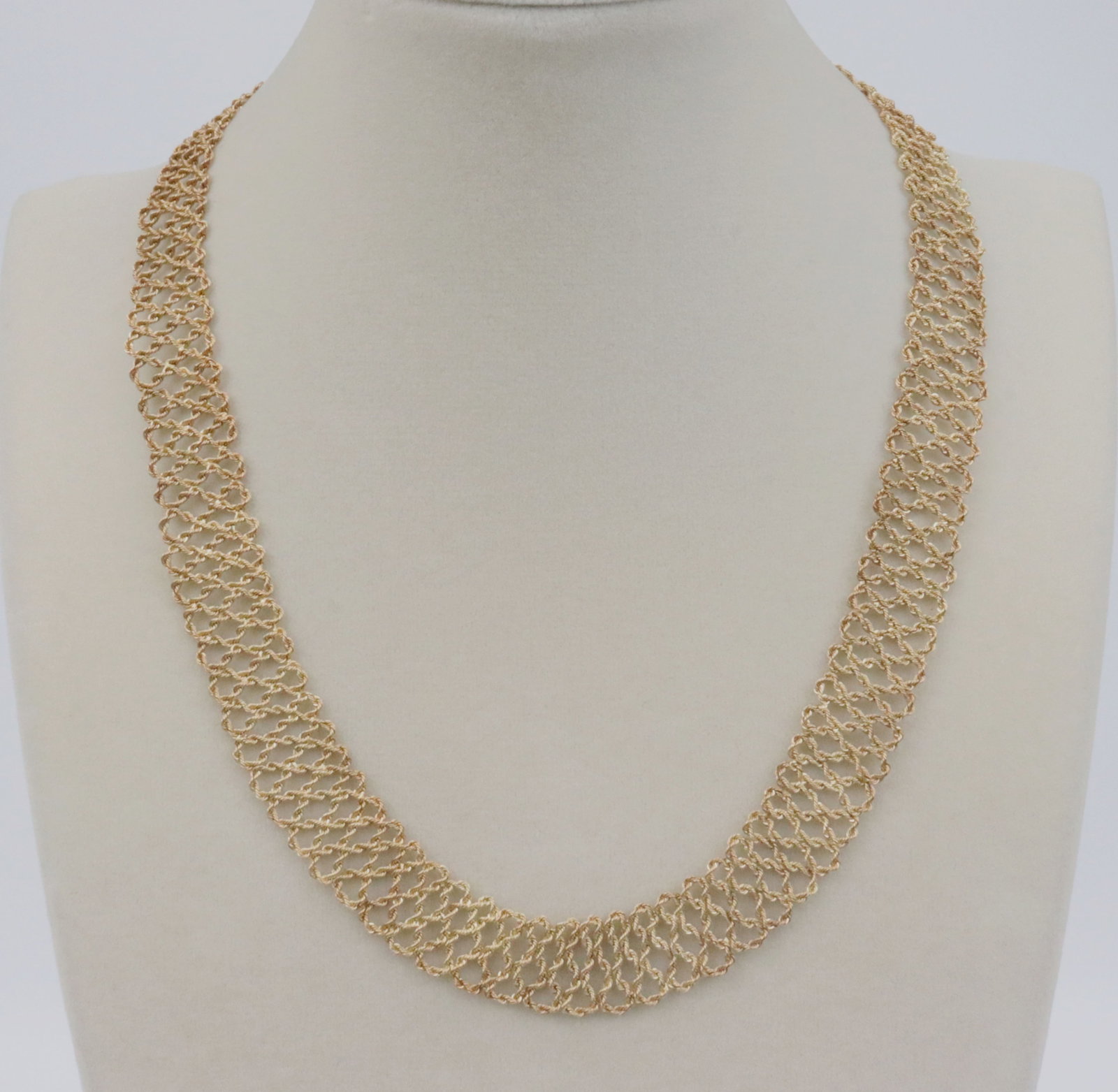 14K WOVEN ROPE-MESH NECKLACE: in flexible intricate lattice design, width 16mm, length 17in., in yellow gold, stamped 14K, 13.6gms., Opening Bid $500