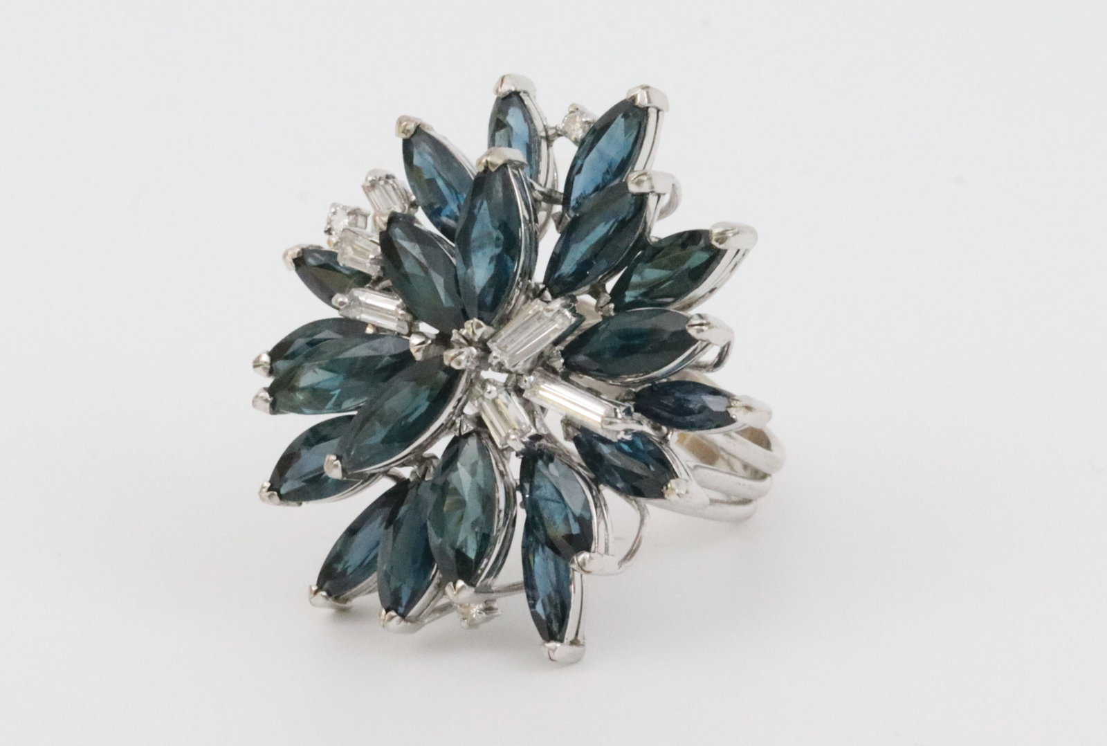 14K SAPPHIRE & DIAMOND COCKTAIL RING: large statement ring featuring 20 marquise sapphires approx. 11.00ctw, and 9 round and baguette natural diamonds approx. 0.65ctw, in white gold, stamped '14K 585 LH', size 7.5, 13.5gms., Opening Bid $
