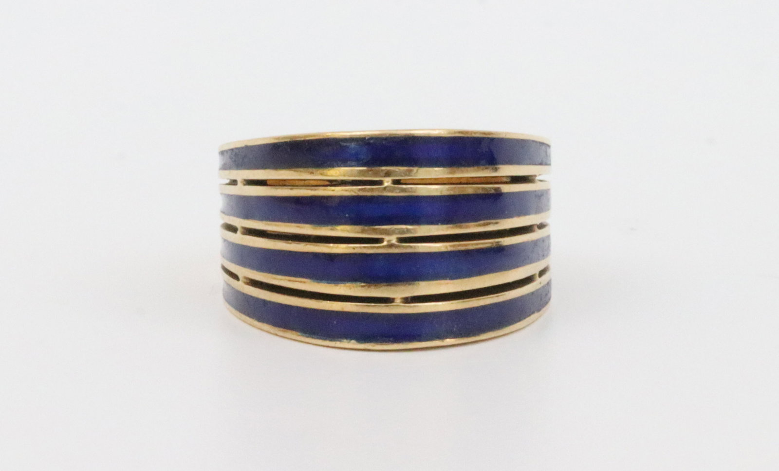 18K BLUE ENAMEL WIDE BAND DOME RING: in yellow openwork gold with blue enameled inlaid stripes (some minor enamel touch-ups observed under magnification), stamped 750, height 12mm, 9.3gms., Opening Bid $600