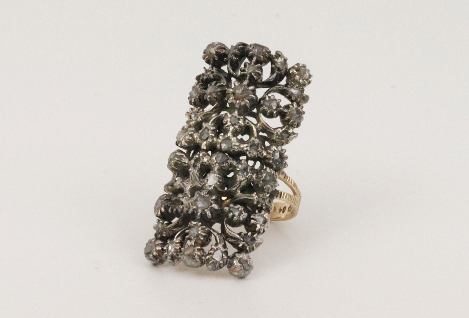 14K SILVER-TOP & ROSE CUT DIAMOND COCKTAIL RING: designed as an elongated rectangular floral filigree statement ring, comprises 42 rose cut diamonds with very rough estimate of approx. 1.00ctw, measures overall 35x17mm, tests silver top over 14K yel