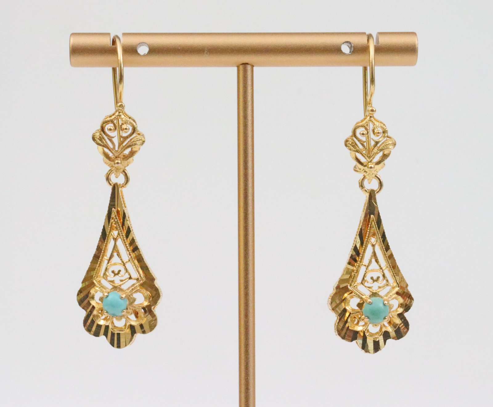 PAIR 18K TURQUOISE DANGLE EARRINGS: c.1970's, each set with a (4mm) turquoise cabochon, in yellow filigree gold, test 18K, overall length 2in., Opening Bid $500