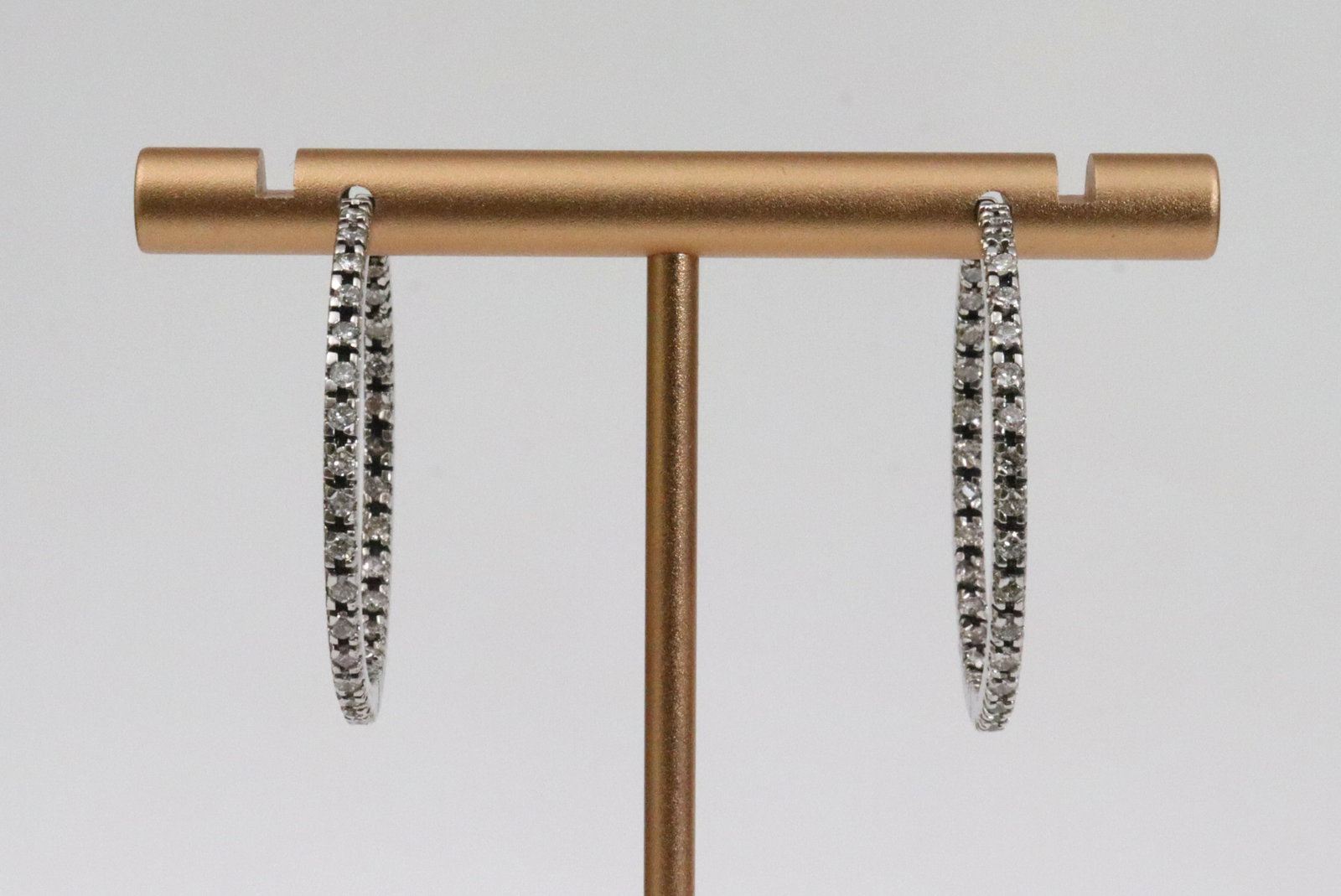 PAIR ITALIAN 18K INSIDE-OUT DIAMOND HOOP EARRINGS: each set with 31 round natural diamonds (lacking one interior diamond), total diamond weight for the pair approx. 0.92ctw, hinged snap post closure, in white gold, stamped 750, 1.2in., 7.1gms.,