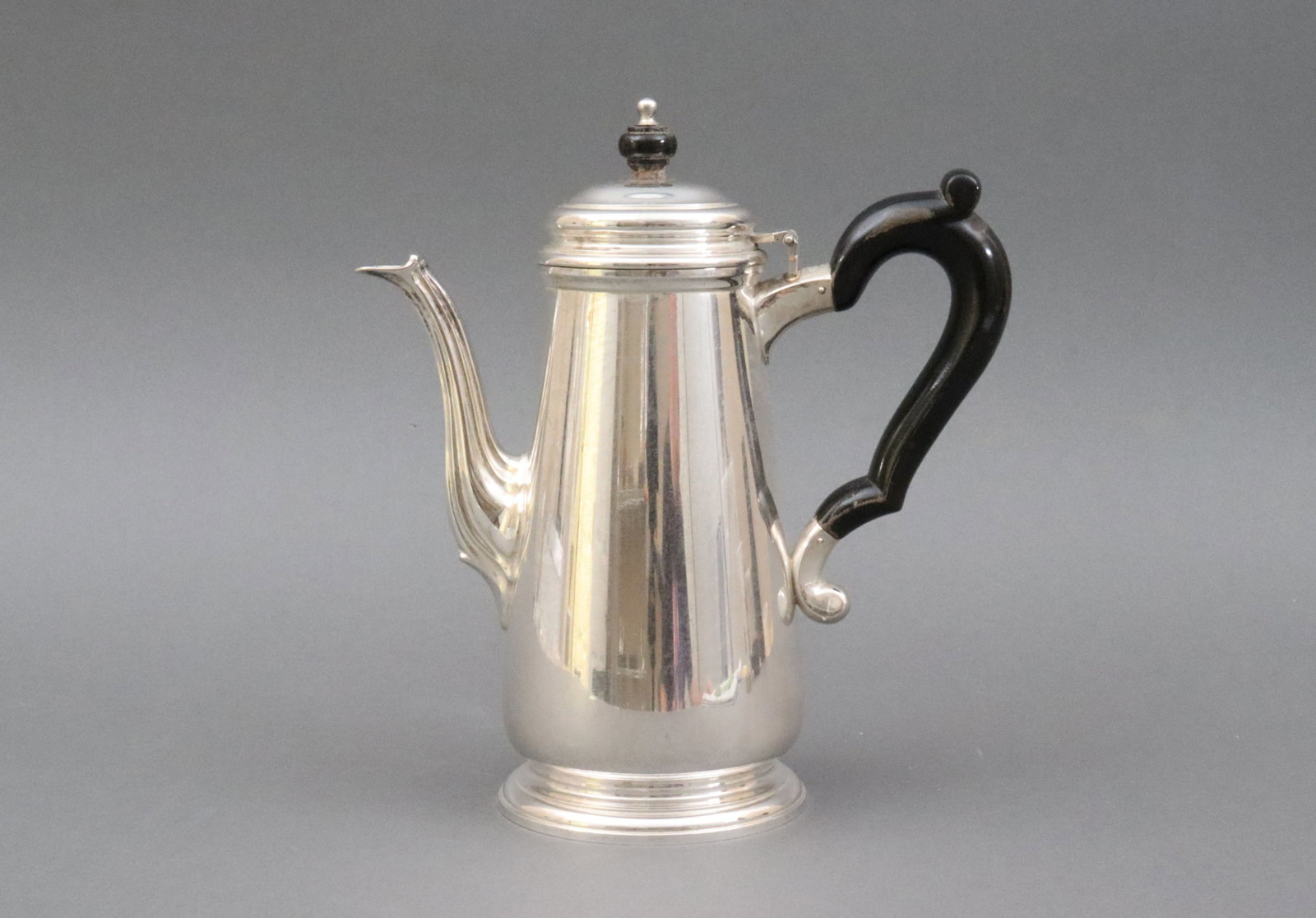TIFFANY & CO. STERLING COFFEE POT: c.1950, with wood handle and finial (some wear and rubs), footed, stamped 'Tiffany & Co. Makers 22938 M', no monogram, 8.5in., 21.5ozt., Opening Bid $700