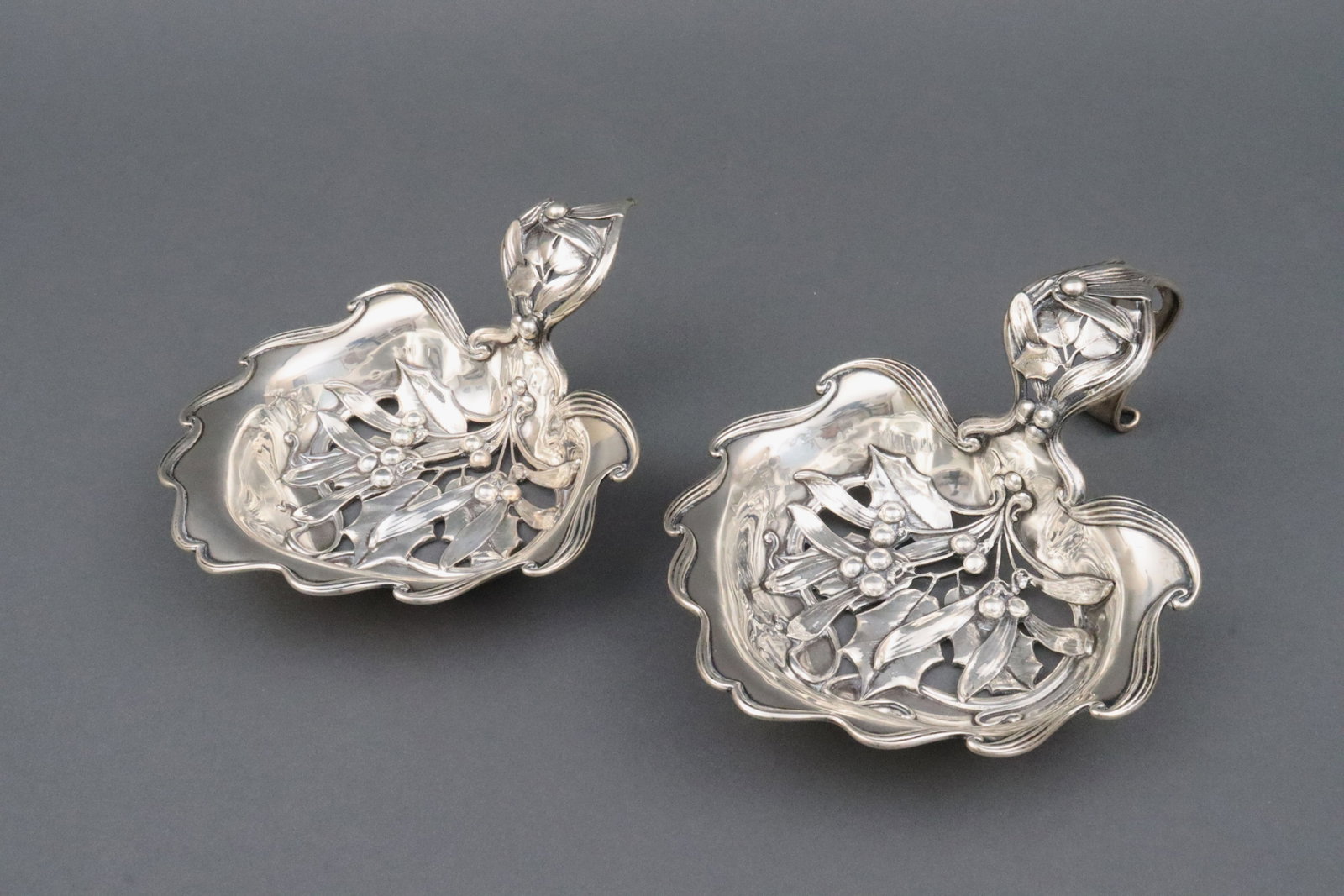 (2) WHITING RETICULATED SERVICE LADLES - ONE AS IS: the nouveau pierced bowls with leaf, berry and scroll decoration, one ladle missing handle, 8.5x6.25in., 16.4ozt., Opening Bid $500