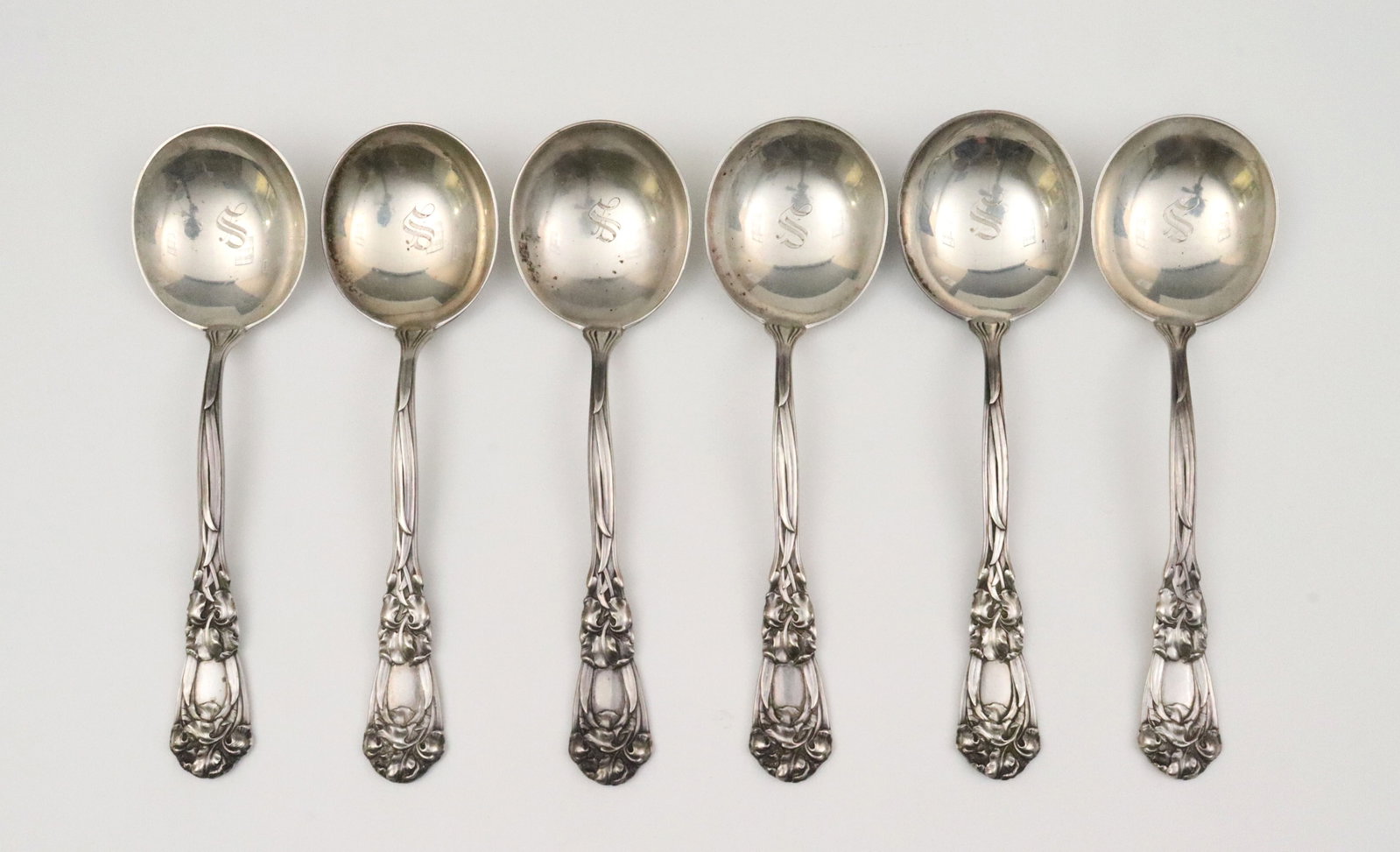 (6) DURGIN STERLING CREAM SOUP SPOONS: in Iris pattern, retailed by Bailey, Banks & Biddle, 7in., monogrammed bowls, 12.5ozt., Opening Bid $400