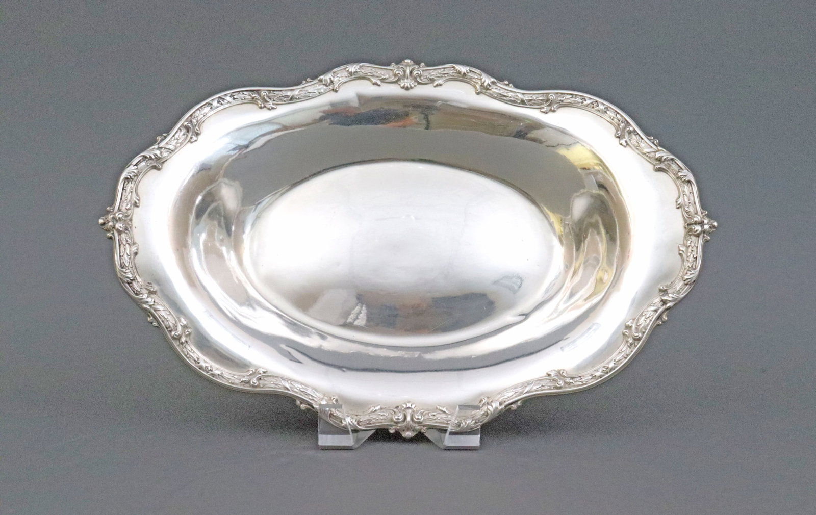 REDLICH STERLING BREAD TRAY: oval form with scroll and leaf trim, 13.5x9in., 14.2ozt., one minor dimple, Opening Bid $400