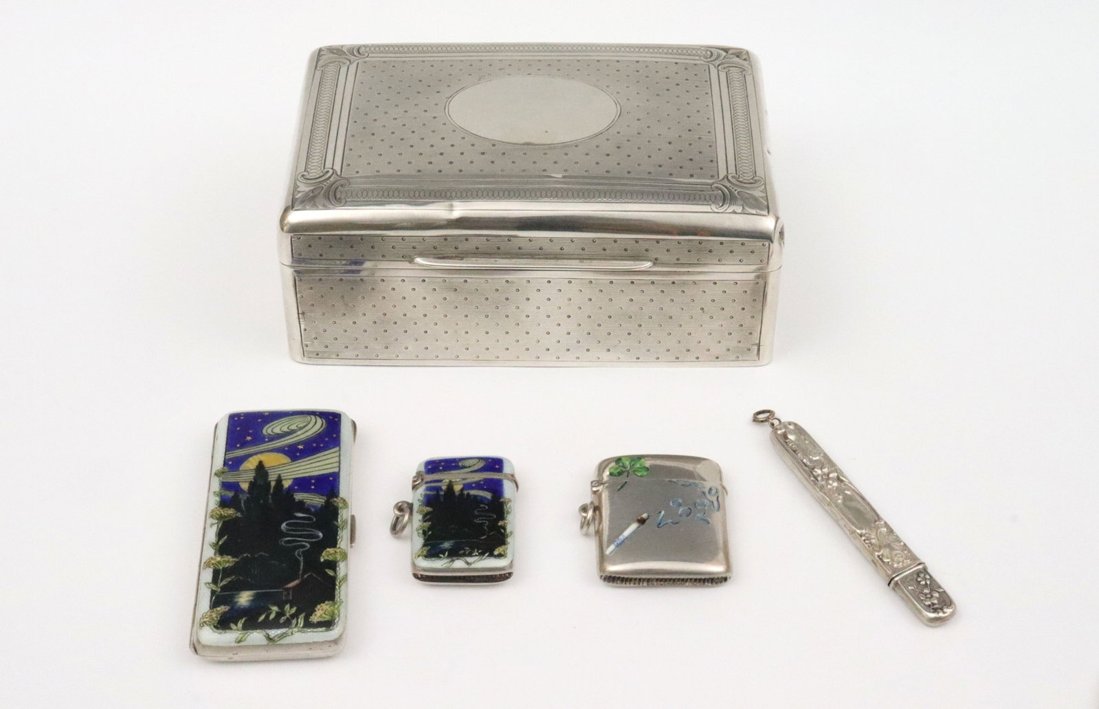 (5) PIECE SILVER SMOKING GROUP: includes an English sterling wood-lined cigarette box with finely dotted engine-turned texturing, hallmarks for London, William Comyns & Sons, 1901 (a few dents), 2.25x5.5x3.5in., a continental 900