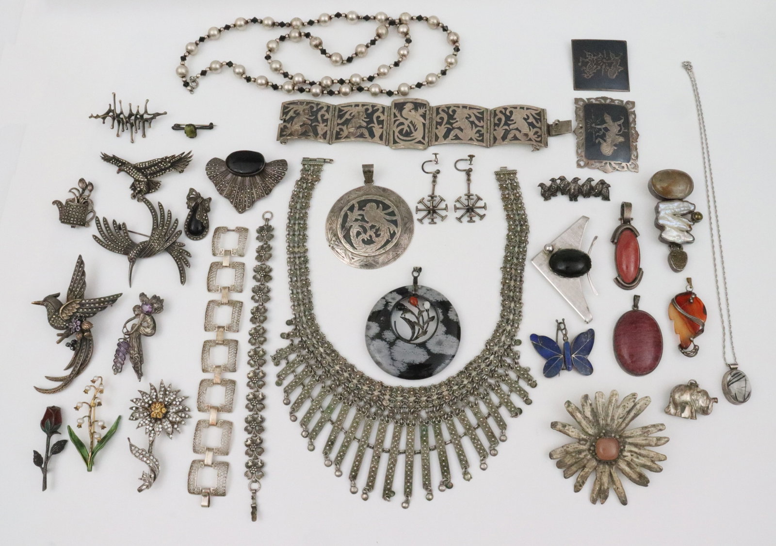 (55+) PIECE SILVER JEWELRY GROUP: including 3 marcasite bird pins, one with amethyst stones, all with ruby eye, largest 3.75", a 16" ethnic style bib necklace, width 3" at longest drop, a 2.25" Amy Kahn Russell free-form pendant