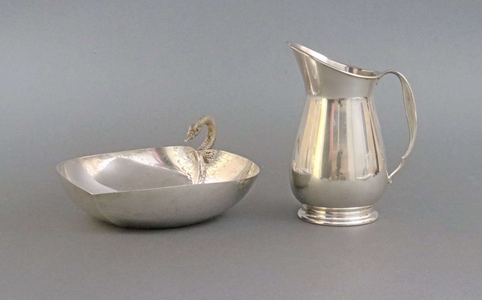 (2) PIECE STERLING TABLEWARE GROUP: includes a hand-chased Tuttle heart-form dish with swan handle, 6in., and a Reed & Barton cream pitcher #X435, with vermeil interior, 5in., no monograms, 10.8ozt., Opening Bid $300