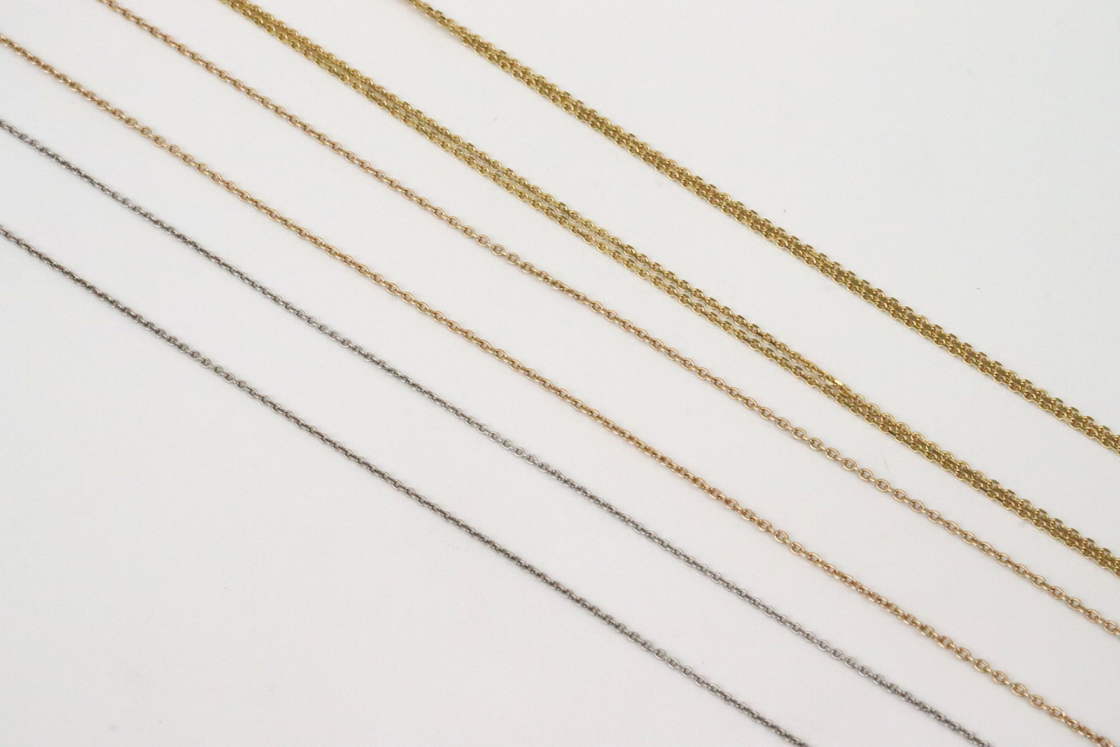 (3) 18K/14K CABLE CHAIN NECKLACES: 18K includes an 18" white gold chain with adjustment link, and a 17" yellow gold Donna del Sole 2-strand necklace, gross weight 5.4gms., and an 18" 14K white gold necklace with adjustment link, 1.6gms