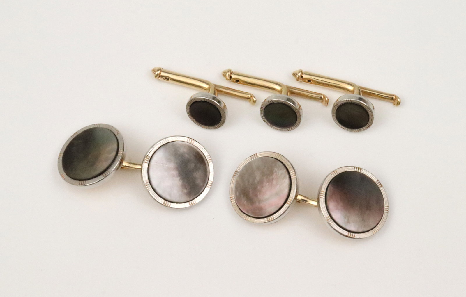 5-PIECE PLATINUM-TOP 14K ABALONE CUFFLINK SET: by Larter & Sons, including a pair of (14mm) button cufflinks, and 3 (8mm) shirt studs, in yellow gold with tested platinum borders, stamped 14K, and with maker?s mark, gross weight 9.9gms., Opening
