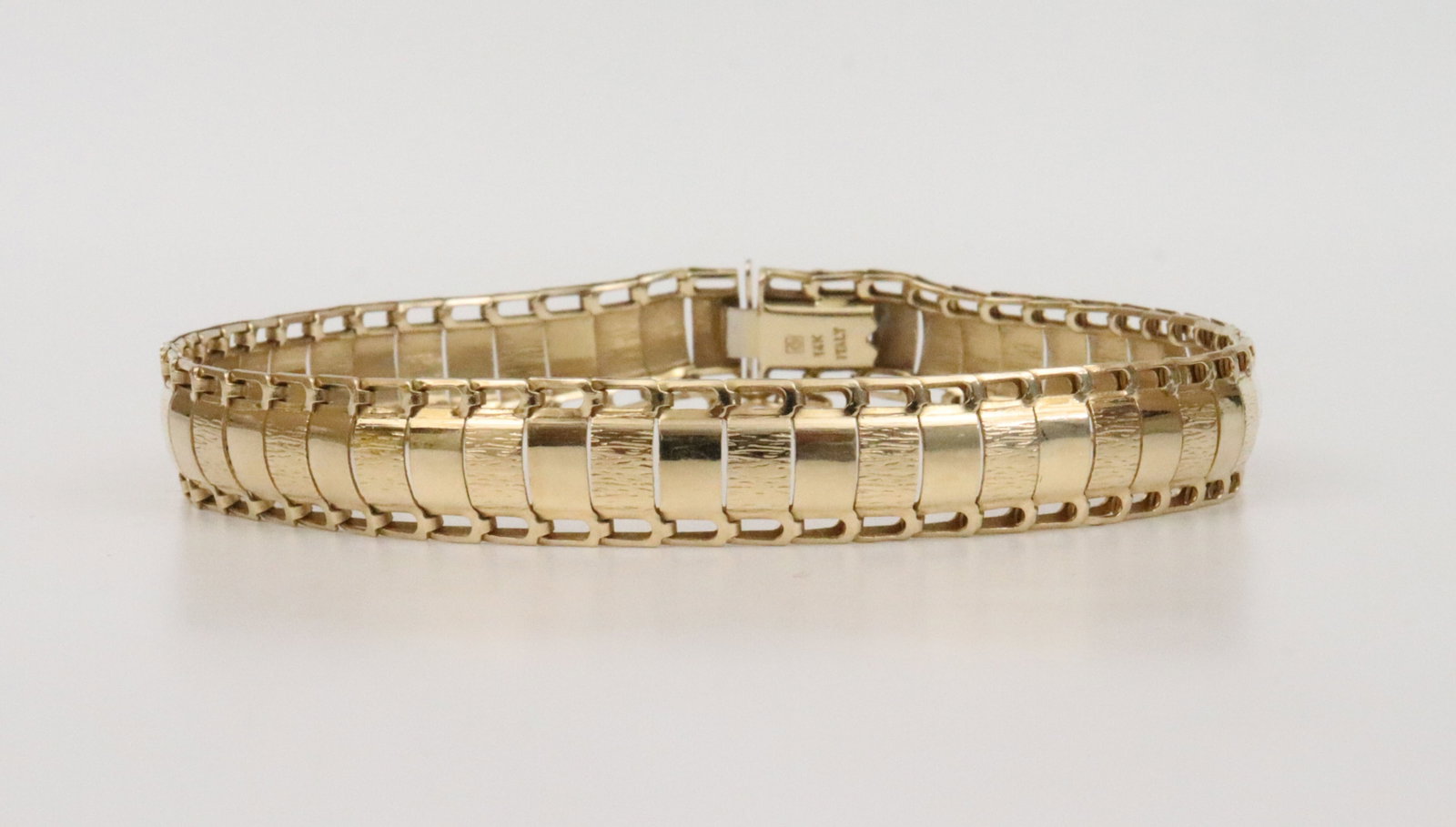 ITALIAN 14K FANCY LINK BRACELET: designed in alternating textured and polished panels, in yellow gold, stamped '14K Italy', width 9mm, length 7.25in., 7.7gms., Opening Bid $300