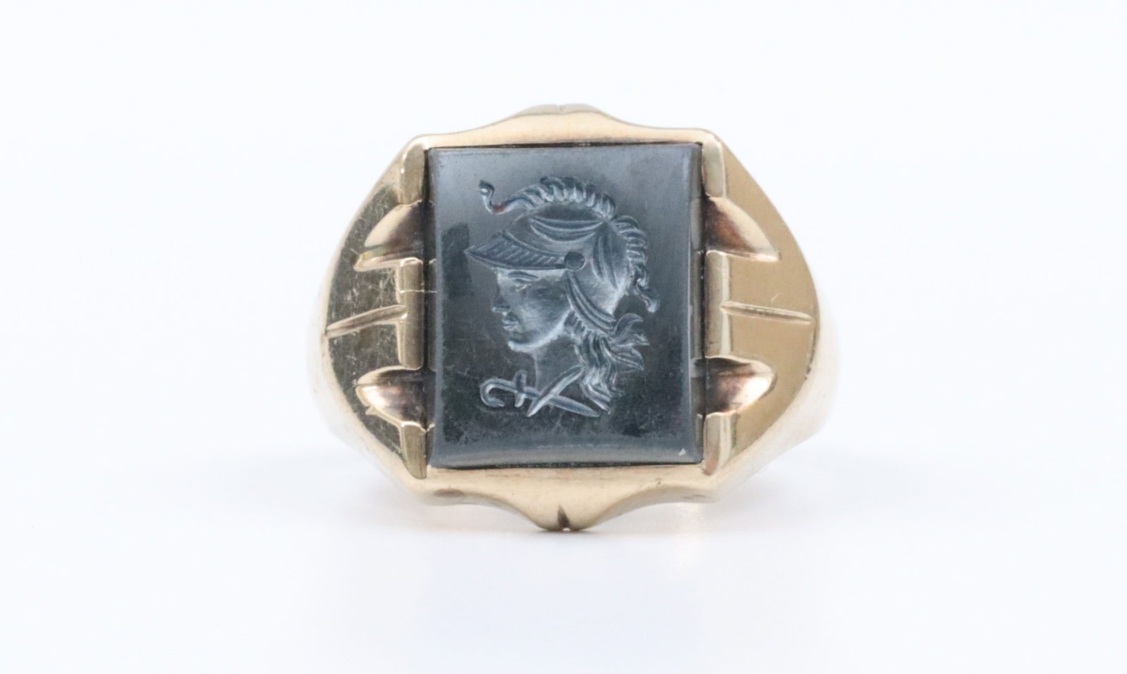 GENTS 10K INTAGLIO RING WITH ROMAN SOLDIER PROFILE: likely hematite, intaglio measures 13x11mm, in yellow gold, stamped 'Dason 10K', size 9.25, intaglio rubs, gold spotting, 8.2gms., Opening Bid $200