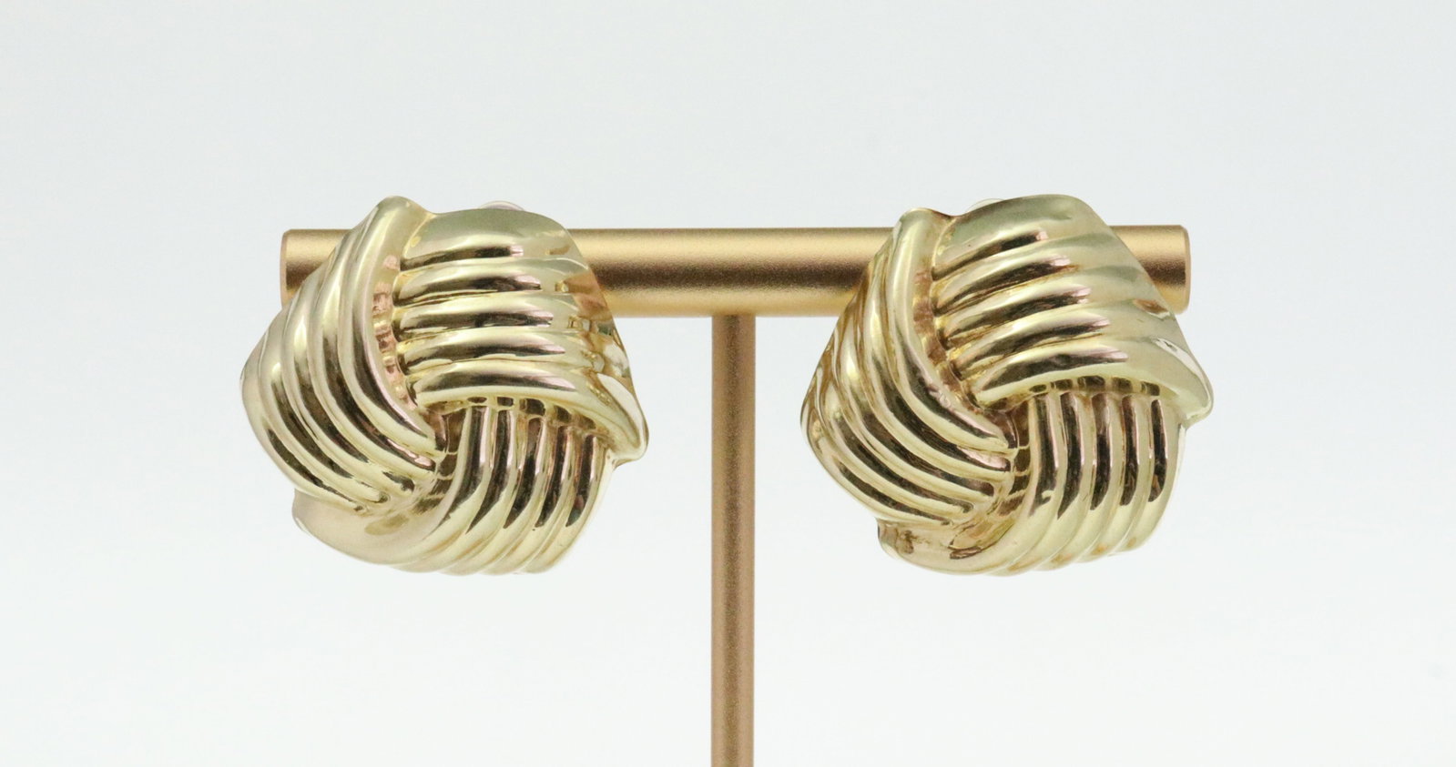 ITALIAN 14K HOLLOW GOLD LOVE KNOT EARRINGS: in yellow gold, stamped '14K BREV Italy', a couple minor dents, posts with some bending, 1in., 5.8gms., Opening Bid $200