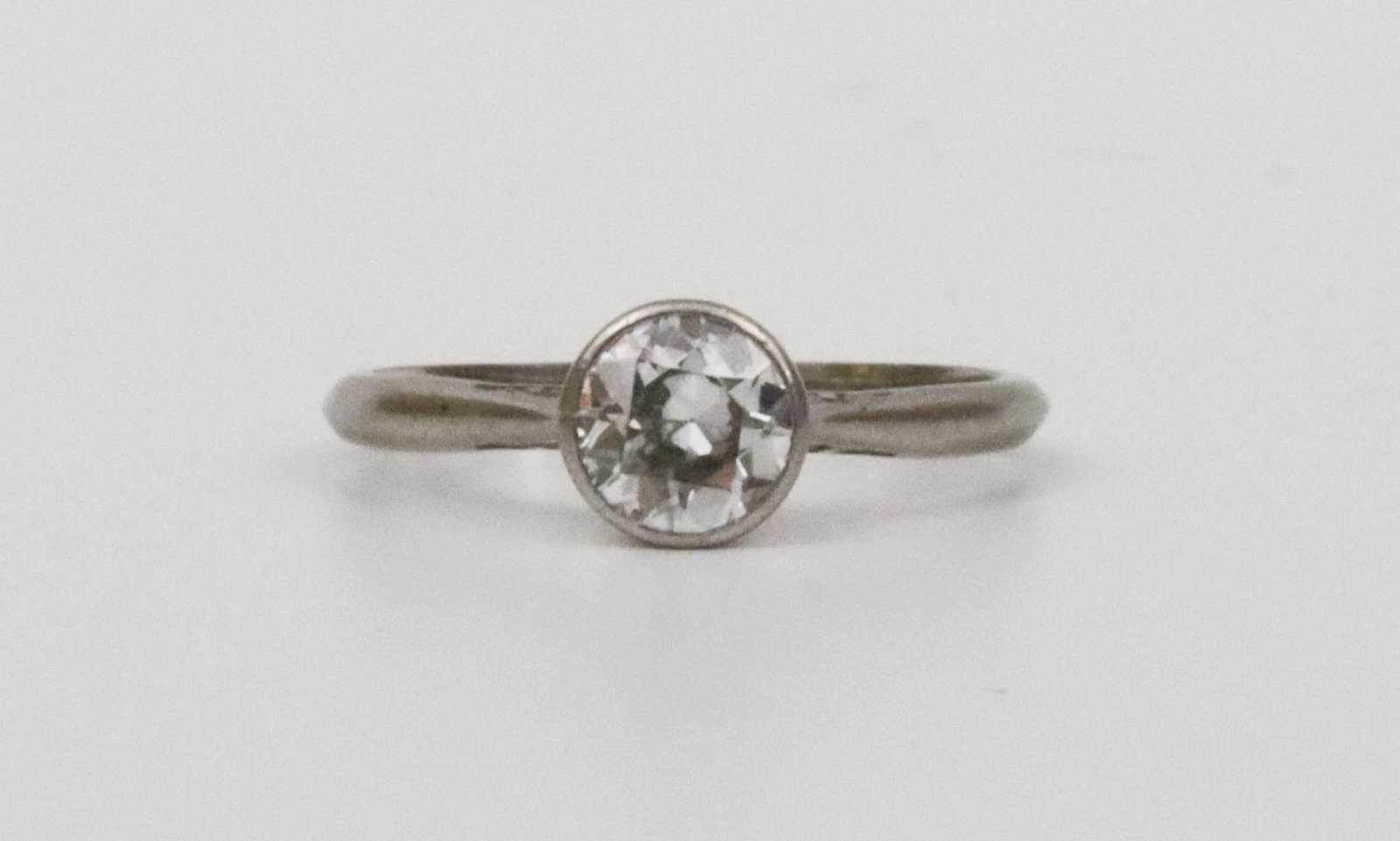ANTIQUE PLATINUM & DIAMOND ENGAGEMENT RING: featuring a single-cut bezel-set diamond approx. 0.50ct (in our opinion: F-G color, VS clarity, however not guaranteed), stamped Plat, size 4.5, 2.1gms., Opening Bid $200