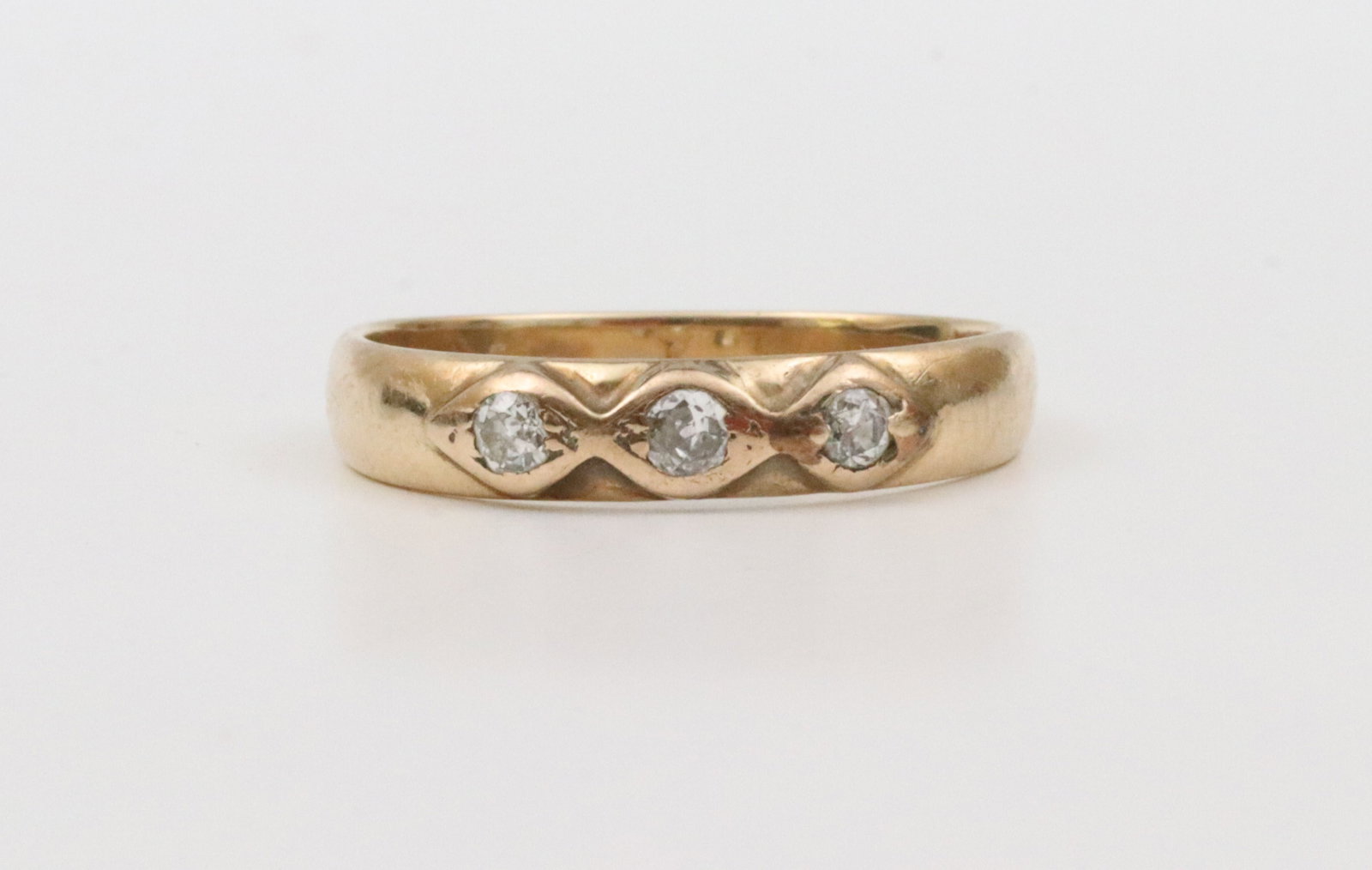 GENTS 14K 3-STONE DIAMOND BAND: featuring 3 round natural diamonds approx. 0.25ctw, in yellow gold, stamped 14K, width 4.5mm, size 11.5, 3.9gms., Opening Bid $150