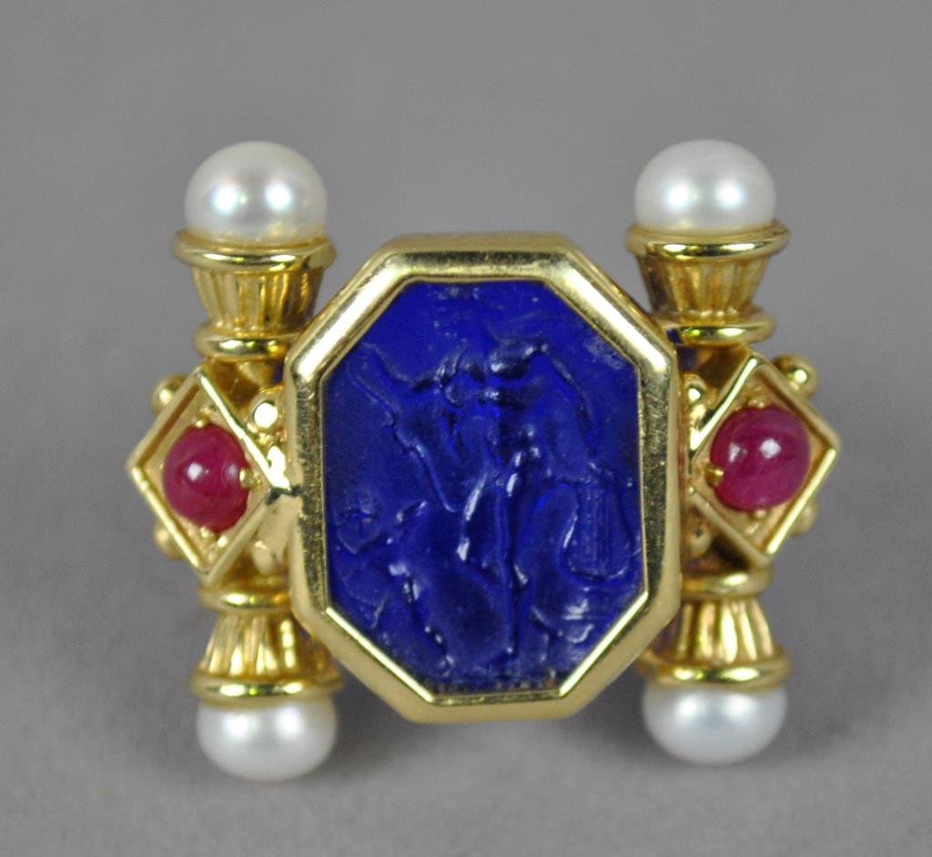 14K TAGLIAMONTE INTAGLIO RING: set with a central octagonal blue glass intaglio depicting a neoclassical scenic with winged figures and a lyre, accented with 2 ruby cabochons and 4 cultured pearls, yellow gold setting stamped 14K I