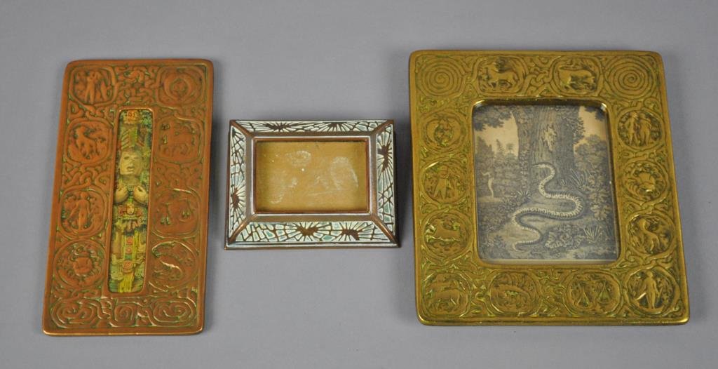 (3) TIFFANY STUDIOS BRONZE DESK ARTICLES: including Pine Needle calendar holder #930, Zodiac picture frame #942, and Zodiac office thermometer #1014 (lacking thermometer), all items missing old patina, tallest 8in.