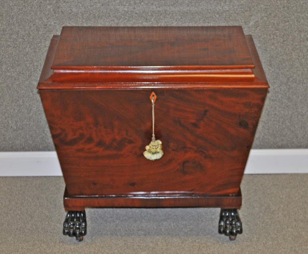 MAHOGANY WINE CELLARET: 20thC., hinged top, black-painted paw feet on casters, 21x25x20in.