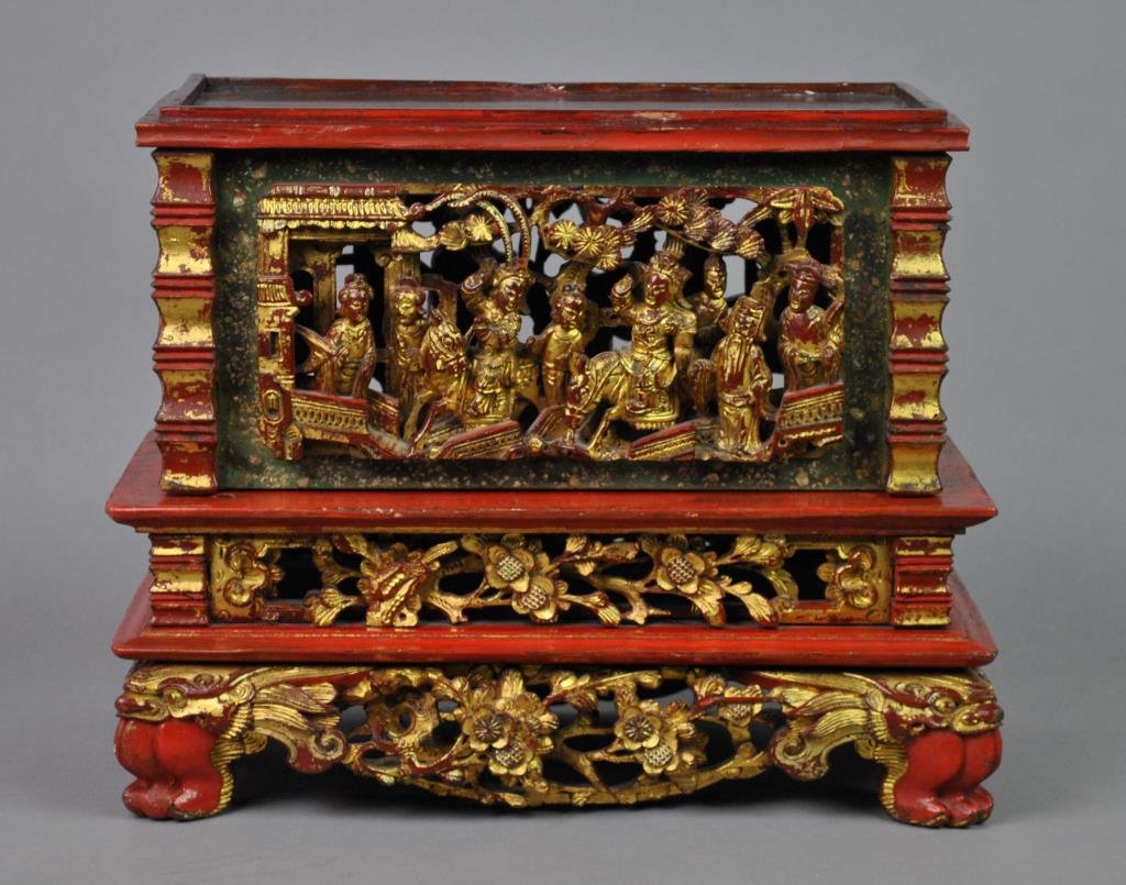 CHINESE CARVED & GILT ALTAR BOX: in two parts, the upper structure with relief carvings on all four panels depicting figural genre scenes, the base structure depicting flora and fauna, on four dragon paw feet, 12x14x8in.