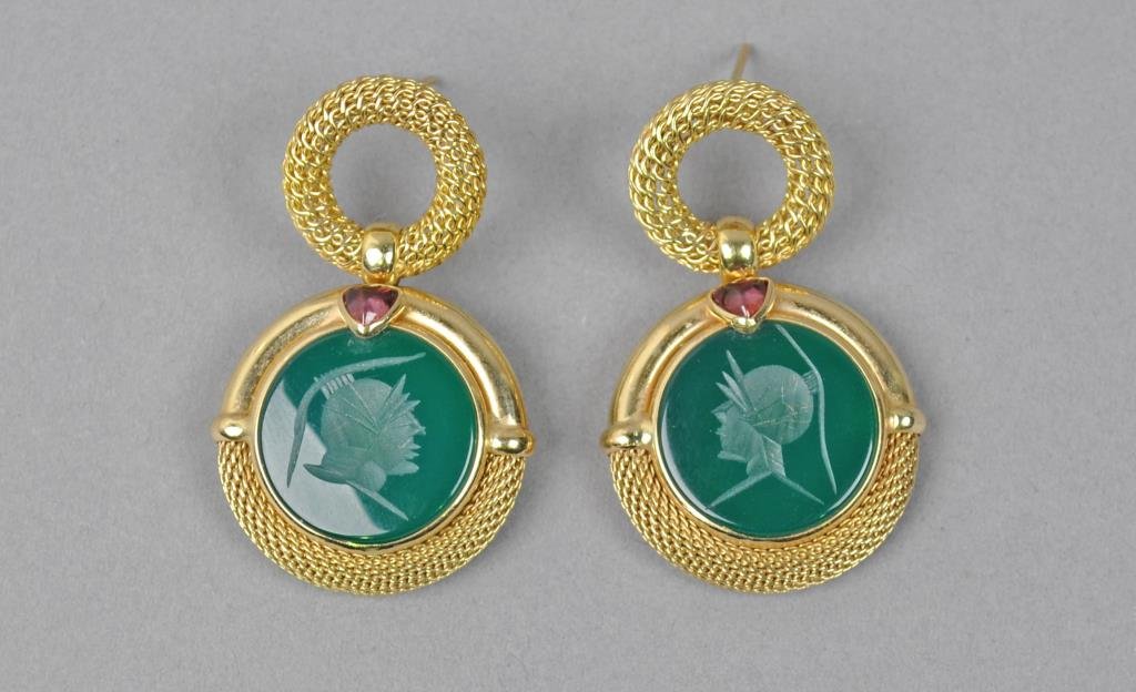 PAIR 14K INTAGLIO GREEN GLASS PIERCED EARRINGS: each accented with a trillion-cut gemstone, yellow gold setting tests 14K, 1.5in., gross weight 14.3gms., no earring backs