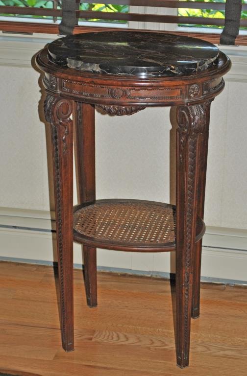 MARBLE TOP OVAL STAND WITH LOWER CANED SHELF: 20thC., carved skirt and tapered legs, 31x18in., marble chip to the underside, some wood distress to inner edge where marble sits