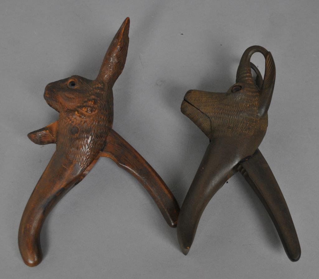 TWO BLACK FOREST (ATTR) CARVED NUT CRACKERS: one in the form of a hare, the other a horned goat, each with glass eyes, tallest 9in.