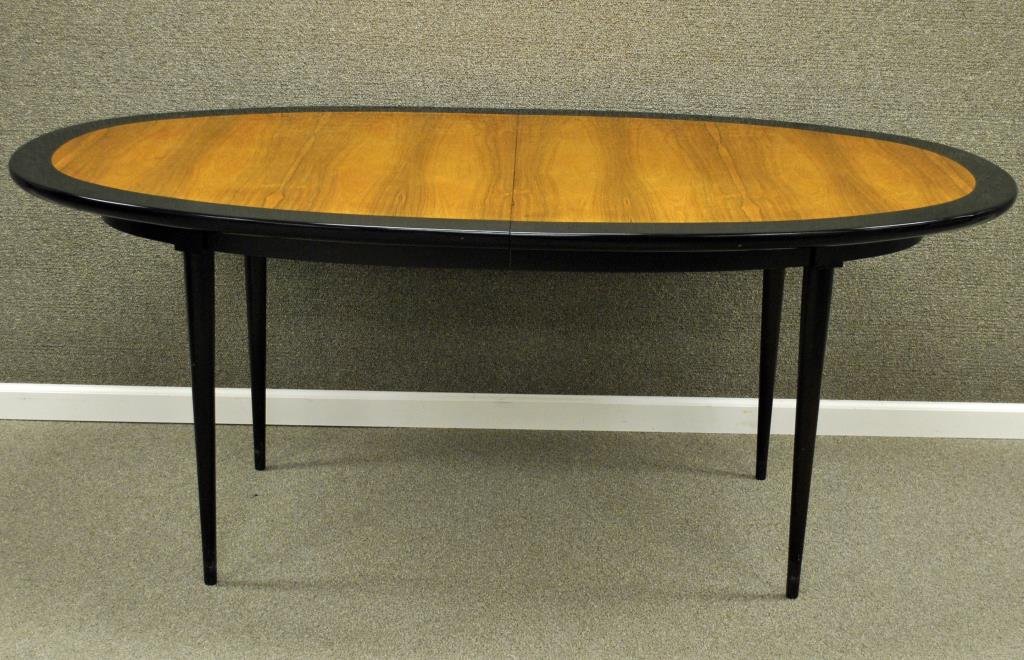HARVEY PROBBER DINING TABLE: in oval form with ebony finish banded top, on tapered legs, 29x72x41in. with four 16" leaves (leaves with finish cracks and chips) extending table to 136in. (center support lacking), unsigned Conditio