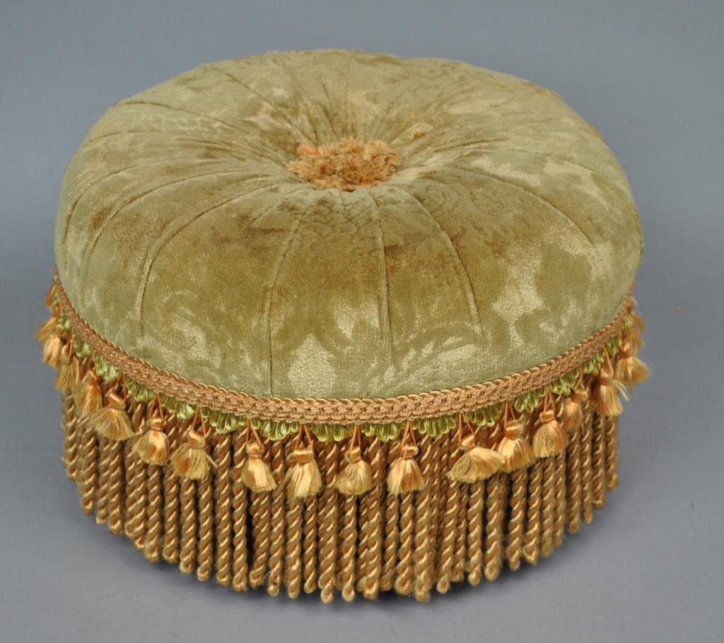 FABRIC UPHOLSTERED FOOTSTOOL: 20thC., on turned feet, 9x14in., lacking one short tassel