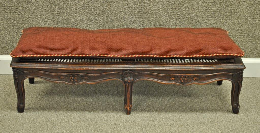 LOUIS XV STYLE CARVED BEECHWOOD DOUBLE FOOTSTOOL: early 20thC., caned top with cushion, 8x32x11in., approx. 2" cane puncture