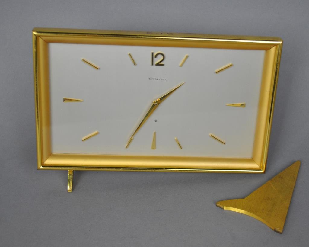 TIFFANY & CO. SWISS BRASS DESK CLOCK: works stamped Angelus, 5.5x8in., working but not guaranteed, brass leg separated from clock (3 broken mini fasteners need to be replaced)