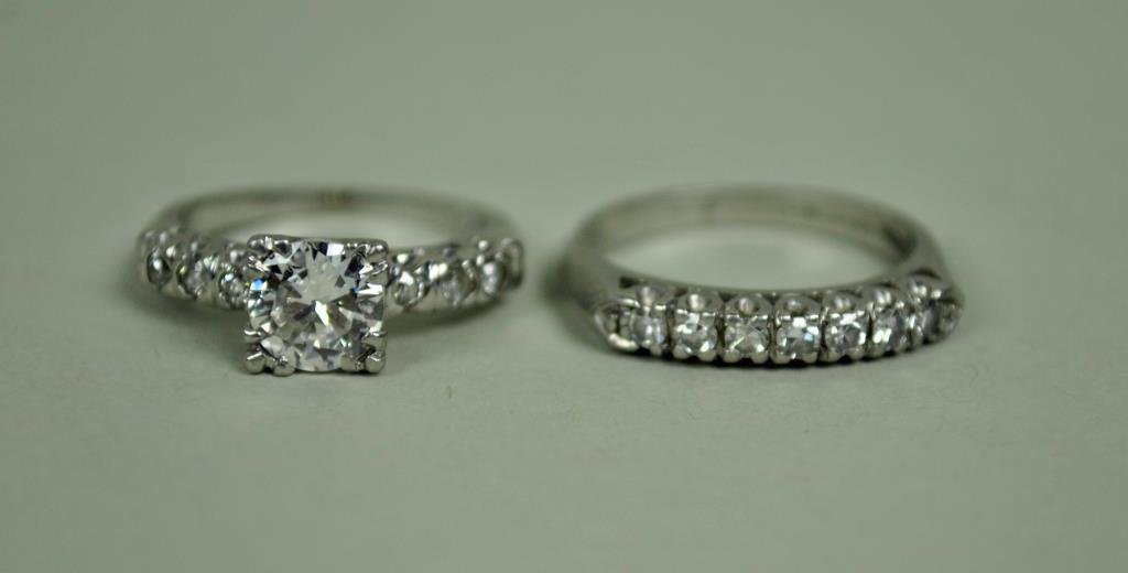 PLATINUM & DIAMOND WEDDING SET, 0.95CTW: the engagement ring set with a round diamond approx. 0.75 carats flanked by 6 diamond melee, the band set with 7 round diamonds approx. 0.14 carats, settings stamped 900 Plat.100 Irid, 8.1gms.