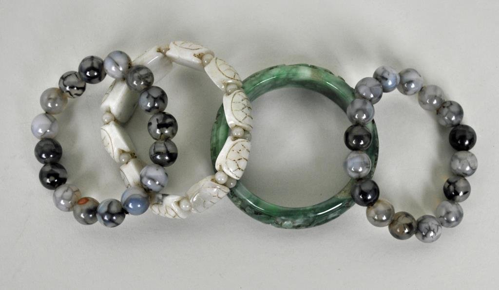 (4) CHINESE JADE BRACELETS: including 2 stretch beaded bracelets, a turtle back stretch bracelet, and a carved bangle, interior diameter approx. 2.25in.