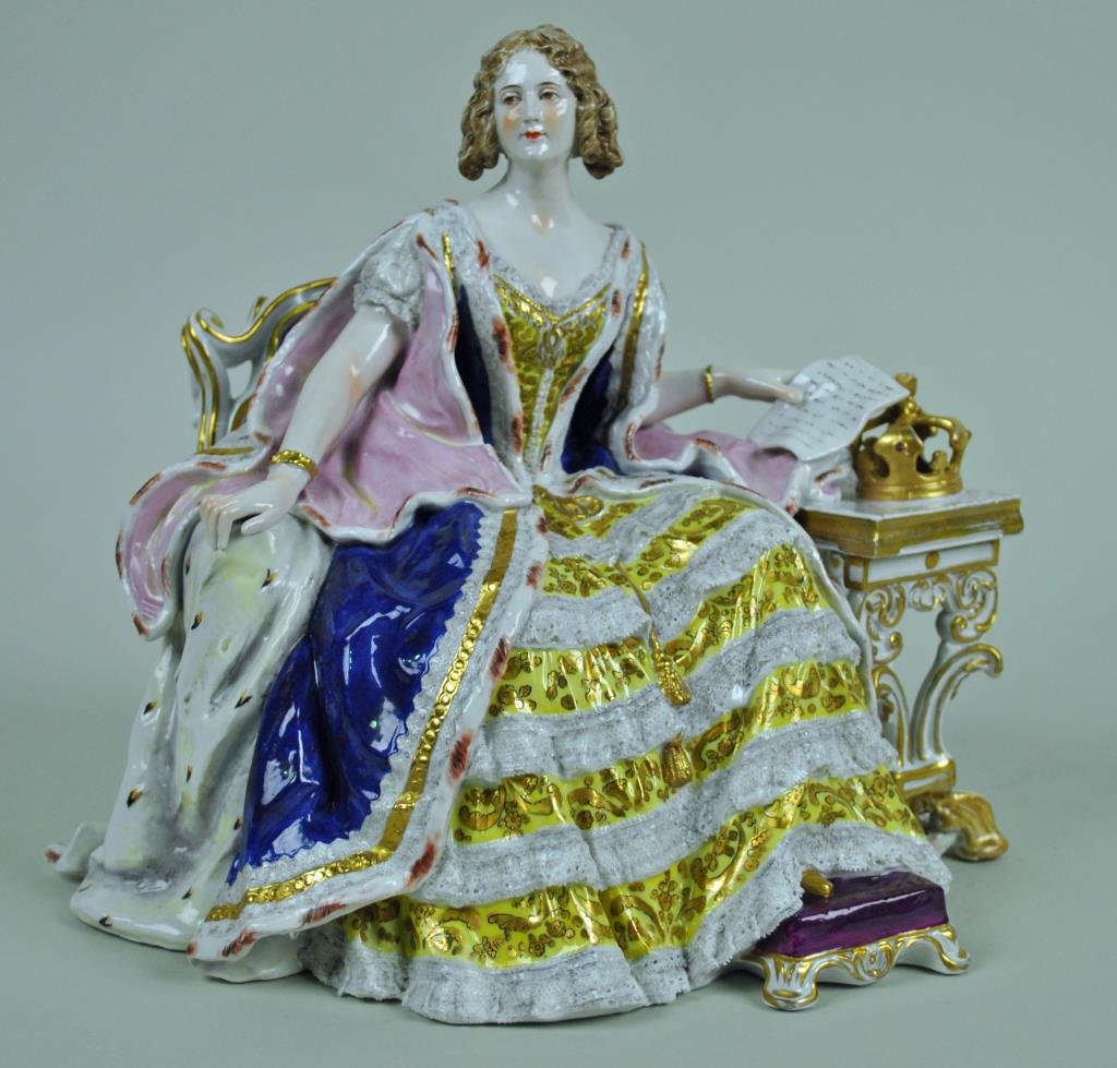 CAPODIMONTE (ATTR) PORCELAIN FIGURINE: finely painted and gilded seated regal figure aside a table with rested crown, underglaze crown over N factory mark, 9x9.5in., front table foot and back chair foot with repair