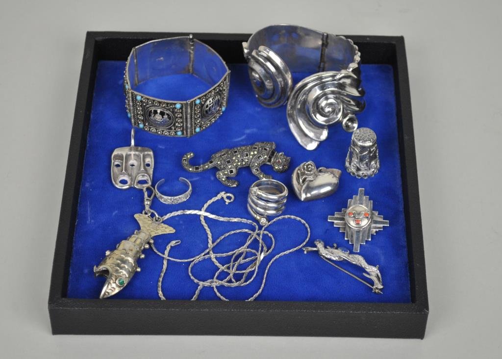 11-PIECE SILVER JEWELRY GROUP: including a Mexican hinged bracelet, a scenic bracelet (one blue stone lacking), a Mexican thimble, a snake pin, a coiled ring, an Israeli mask pendant, a heart pendant, a marcasite animal pin, a 30" 