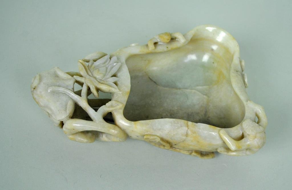 CHINESE CARVED JADE BRUSH WASHER: likely Qing, 2x7.25in., carved as lotus issuing long stem projections to the reverse with two clinging chilong peering over the rim, no chips or repairs observed, cracks appear to be natural stone fis