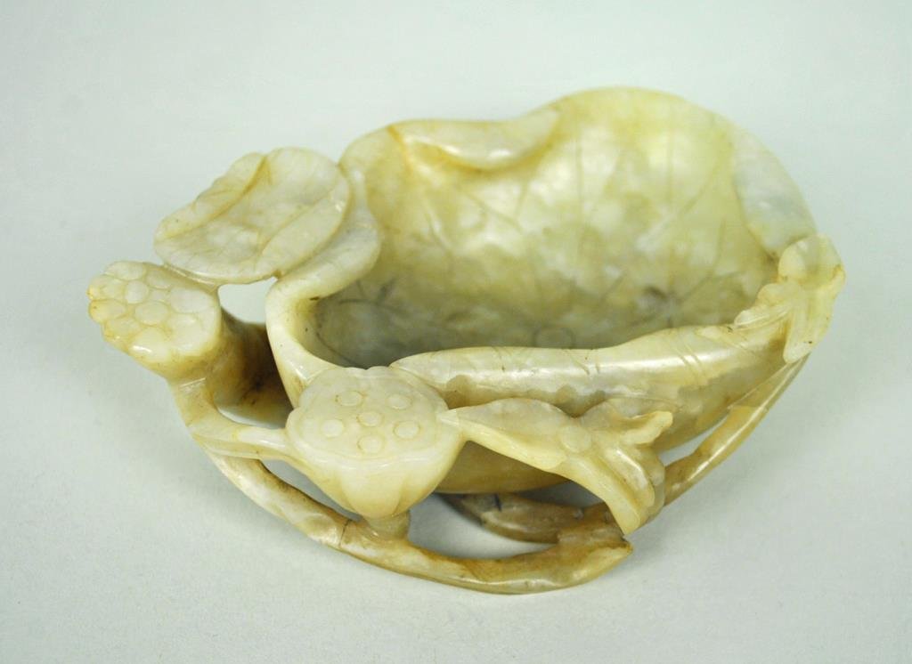 CHINESE CARVED JADE BRUSH WASHER: likely Qing, 1.5x5in., carved in assorted blossom motif issuing long stem projections to the reverse, no chips or repairs observed, Estate Collection